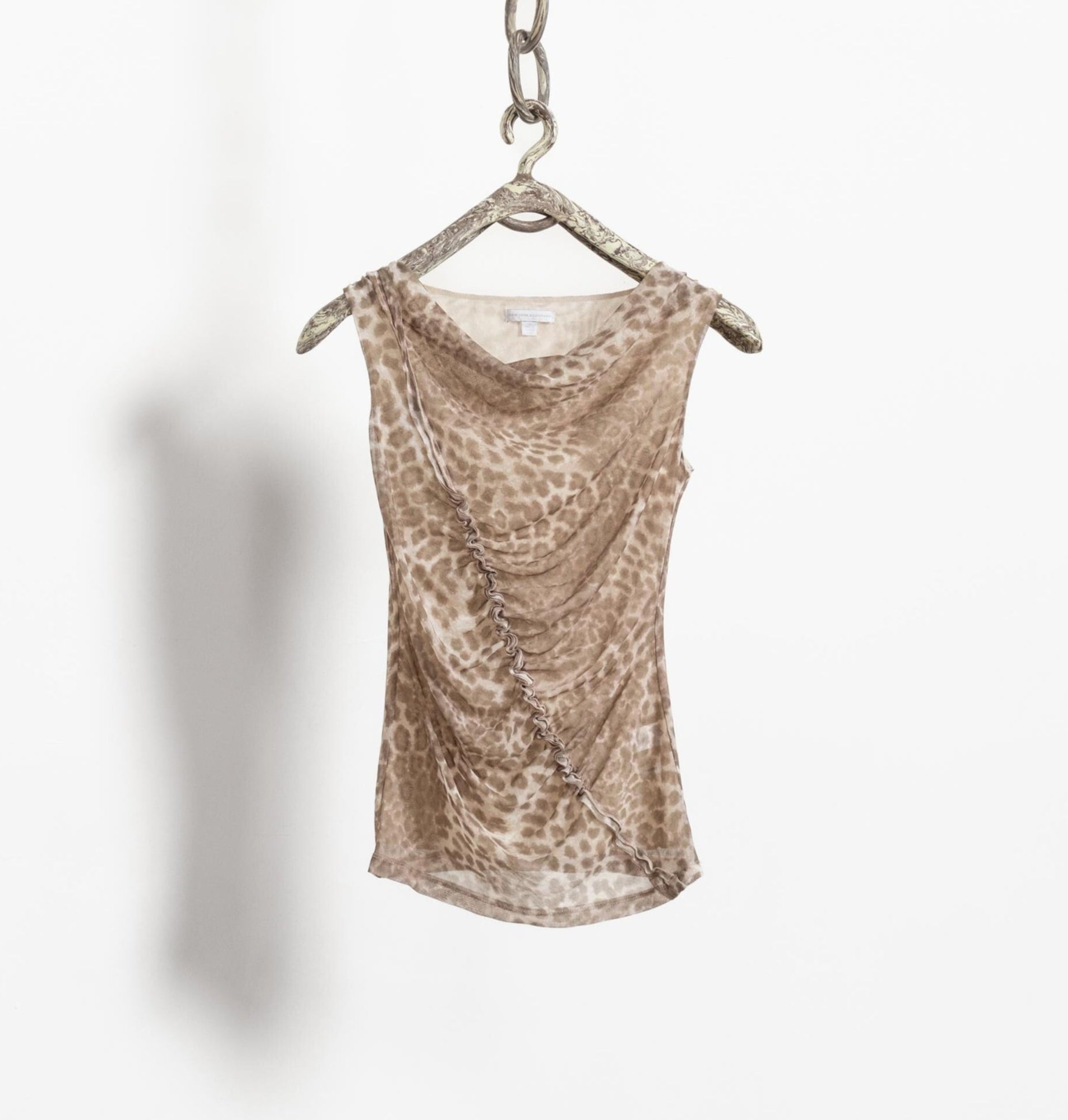 Leopard print dress on a hanger against a white background