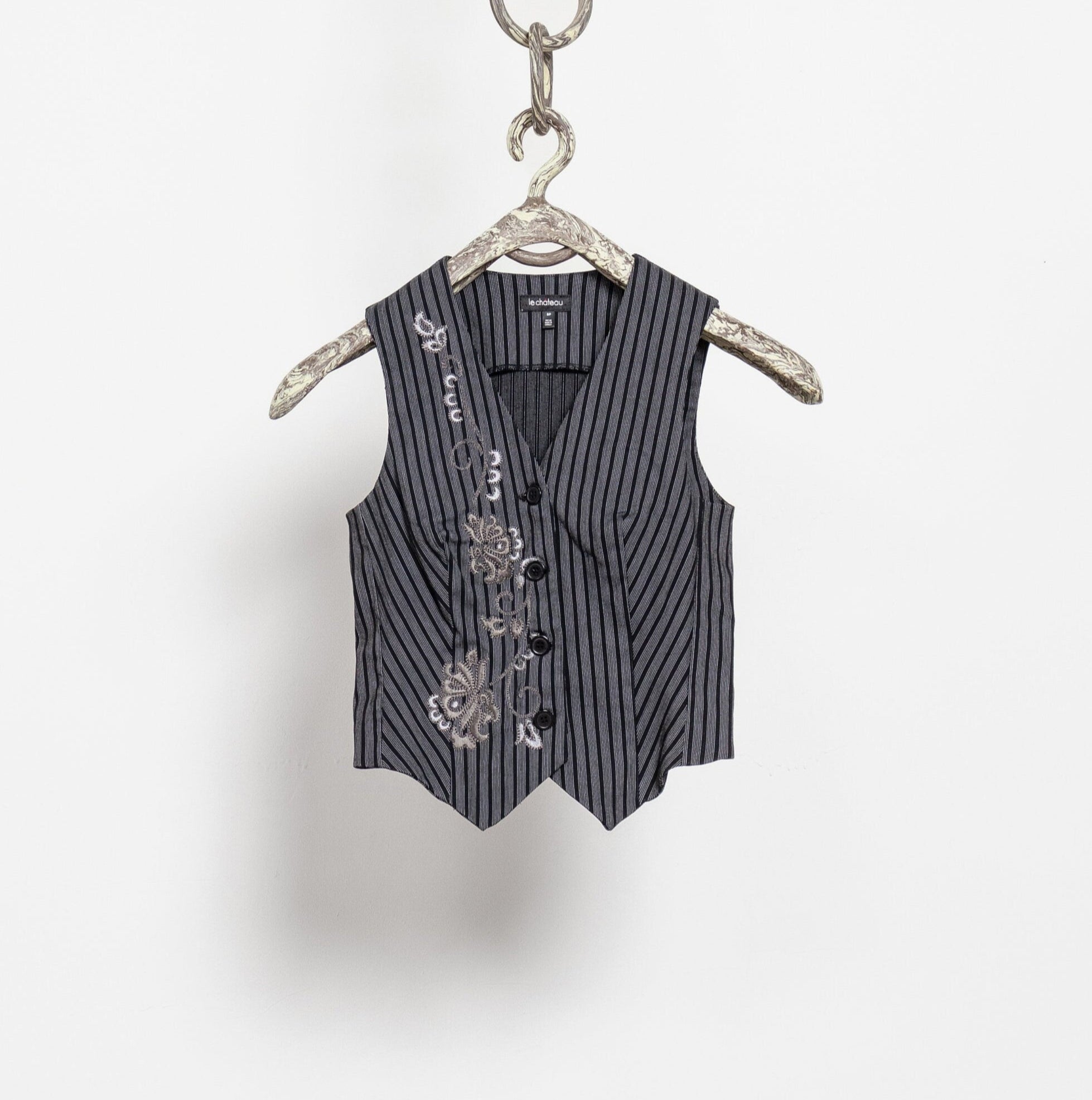 Black pinstripe vest on a hanger against a white background