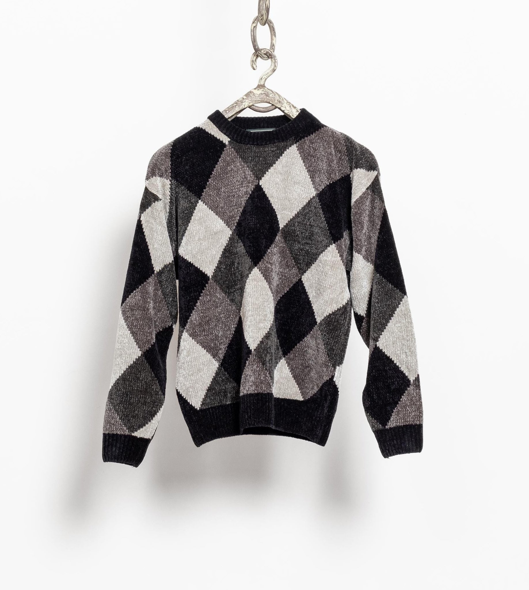 A vintage 90's acrylic chenille pullover dad sweater with a textured diamond pattern in shades of silver, grey, and black, displayed on a hanger against a white background.