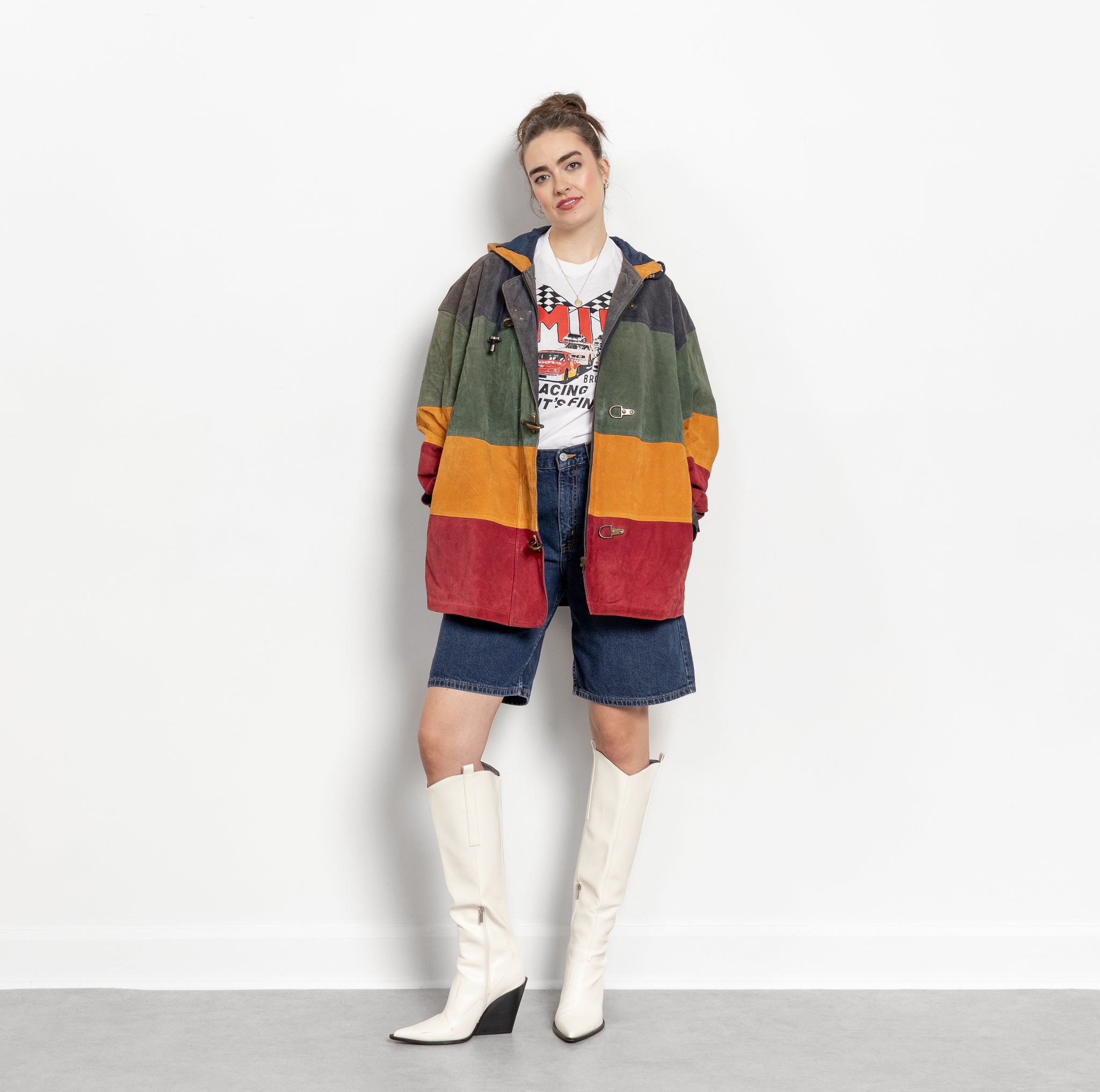 Person wearing a colorful striped coat with a white background