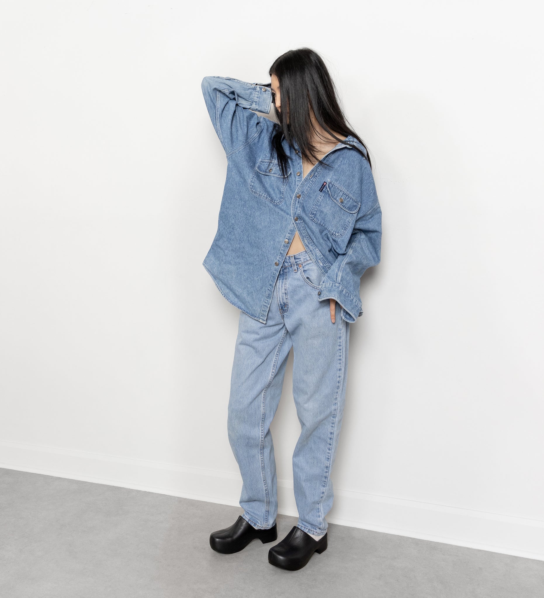 Person wearing a denim outfit against a white background