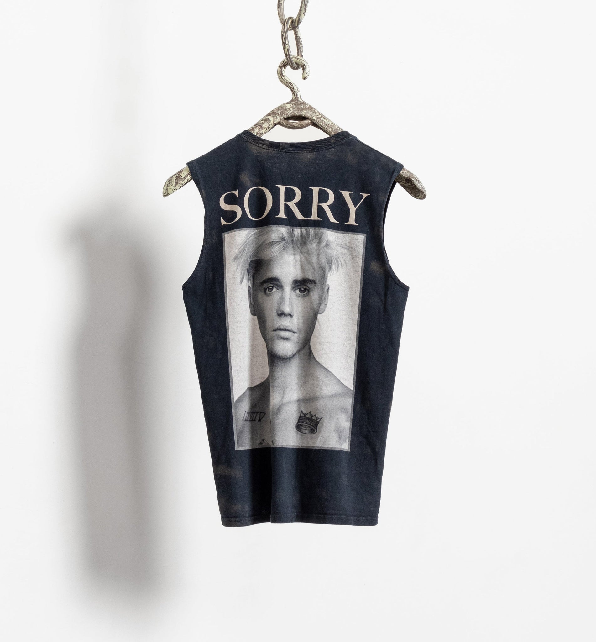 A black graphic tee with the text 'SORRY' and a photo of a person, presumably Justin Bieber, in the center.