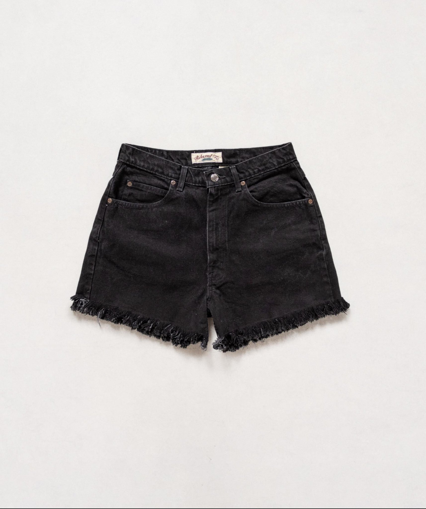 Black denim shorts with frayed edges on a white background