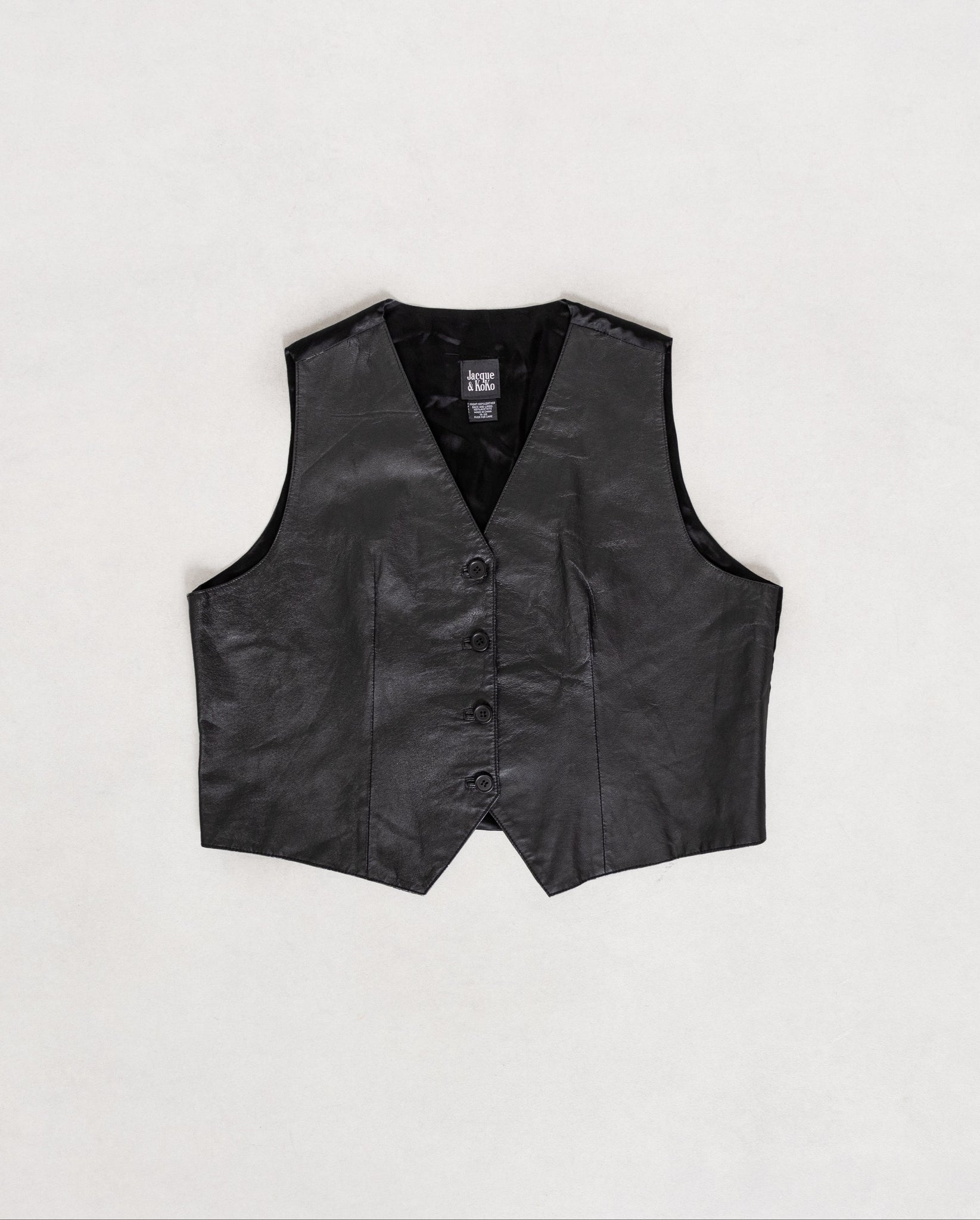 Black leather vest on a light gray background