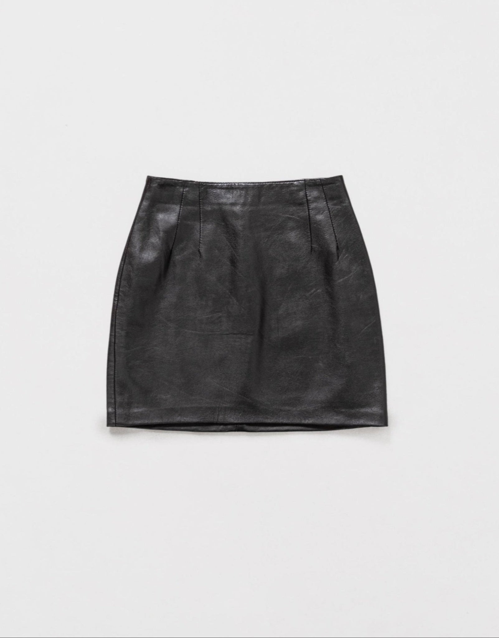Black leather skirt on a light gray background
