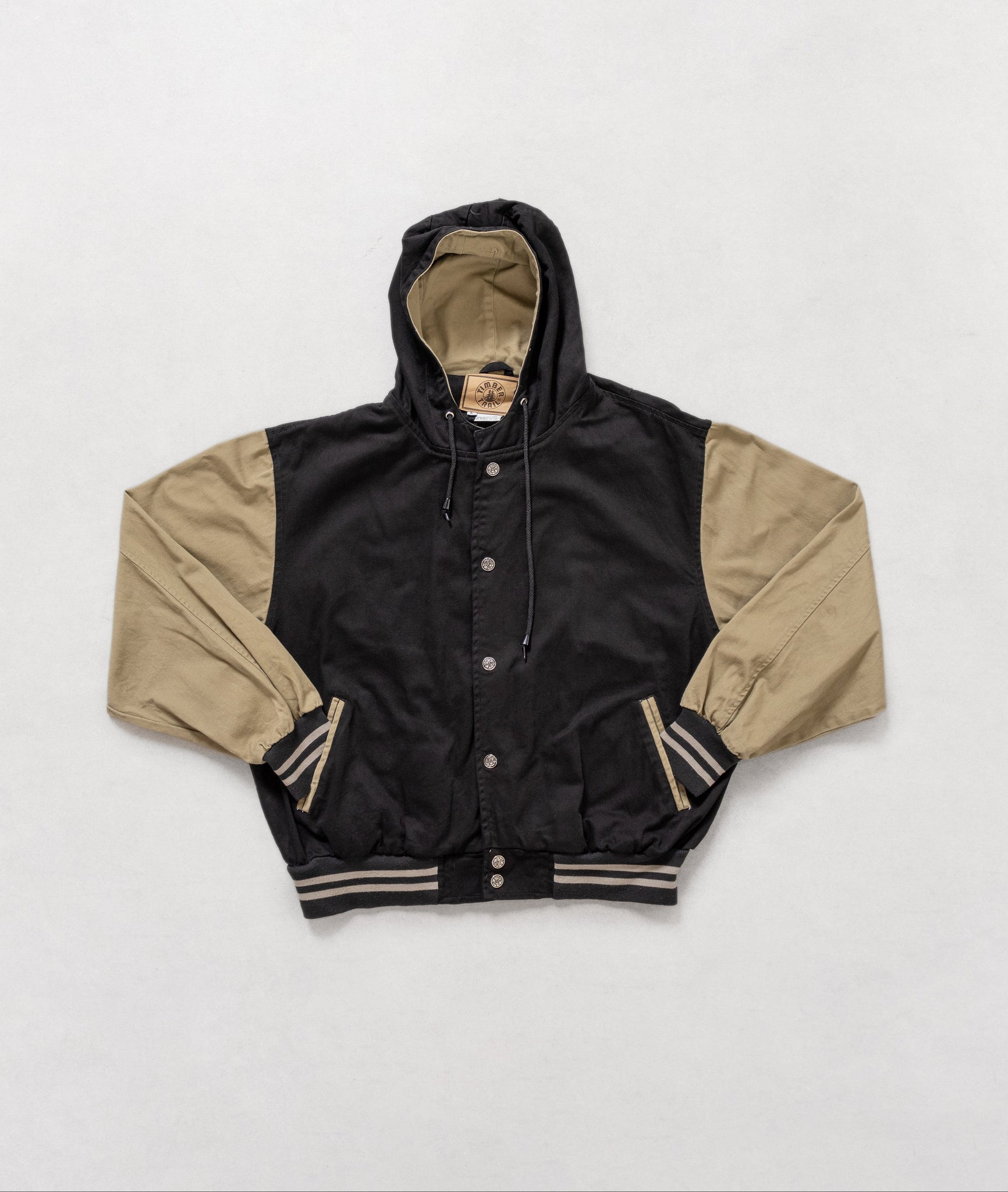 Black and beige jacket with a hood on a white background