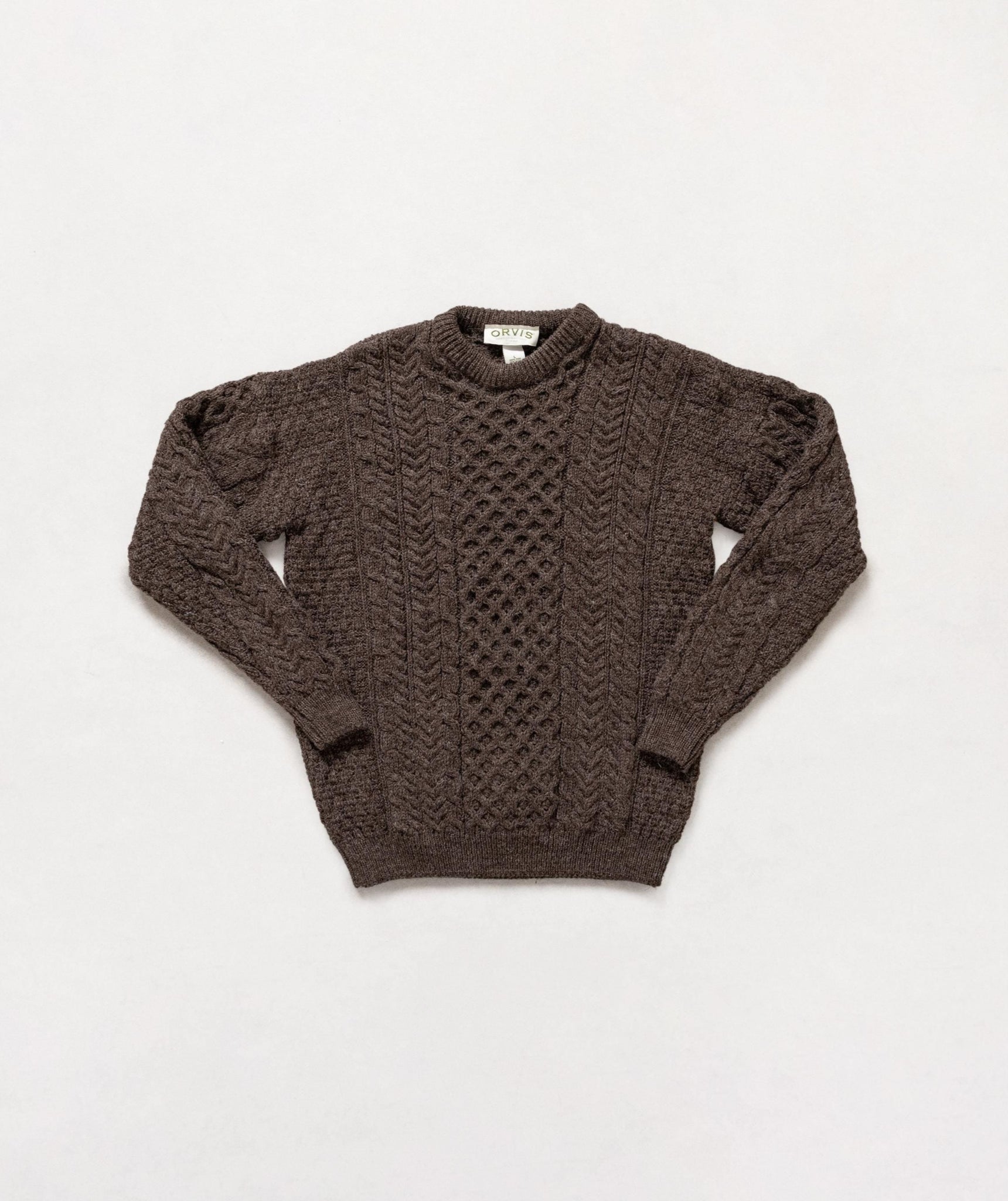 Brown knitted sweater on a light gray background