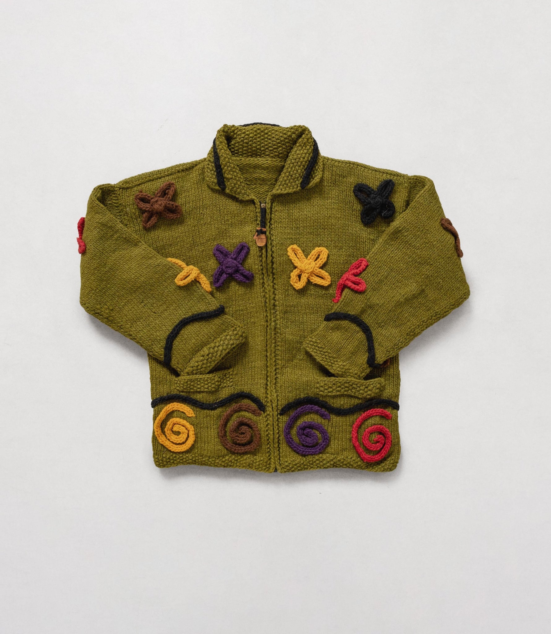 Green knitted jacket with colorful patterns on a white background