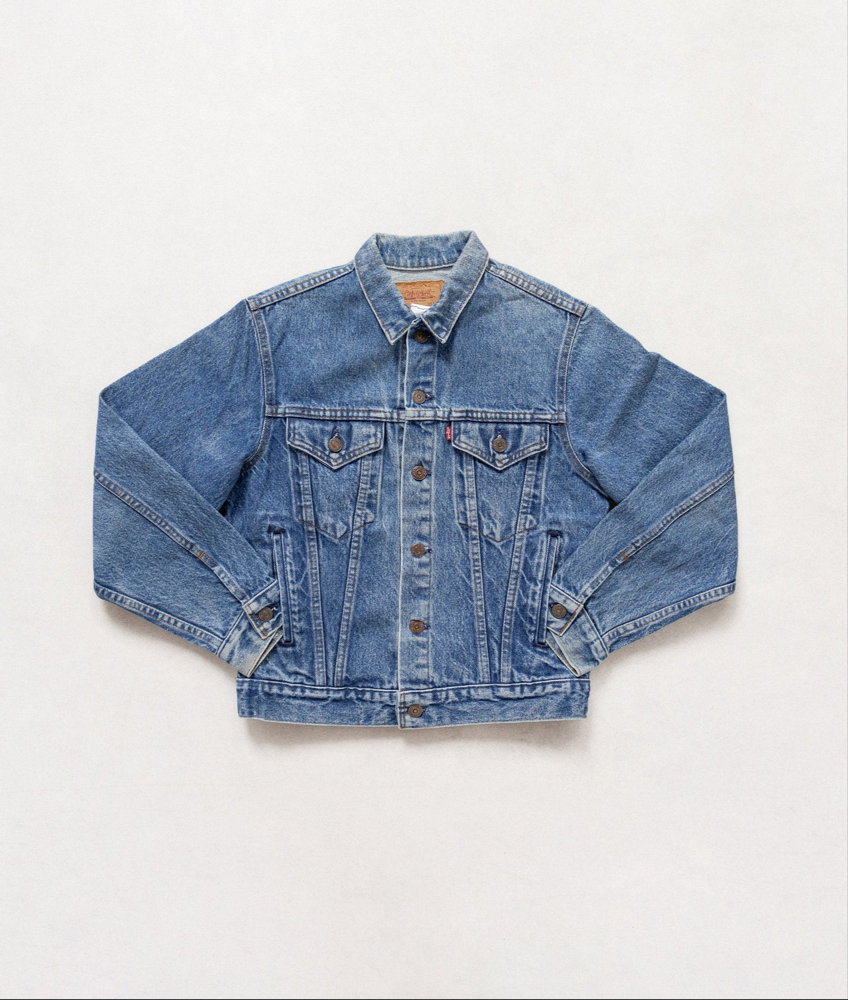 Blue denim jacket on a white background
