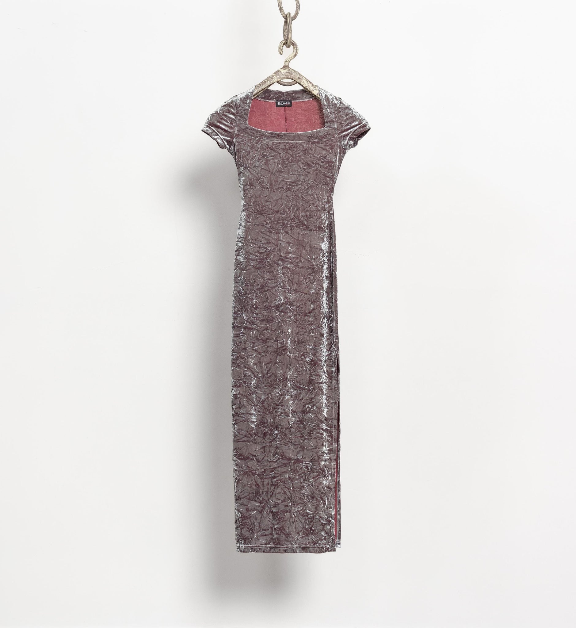 Long, dark gray dress with a red lining on a white background