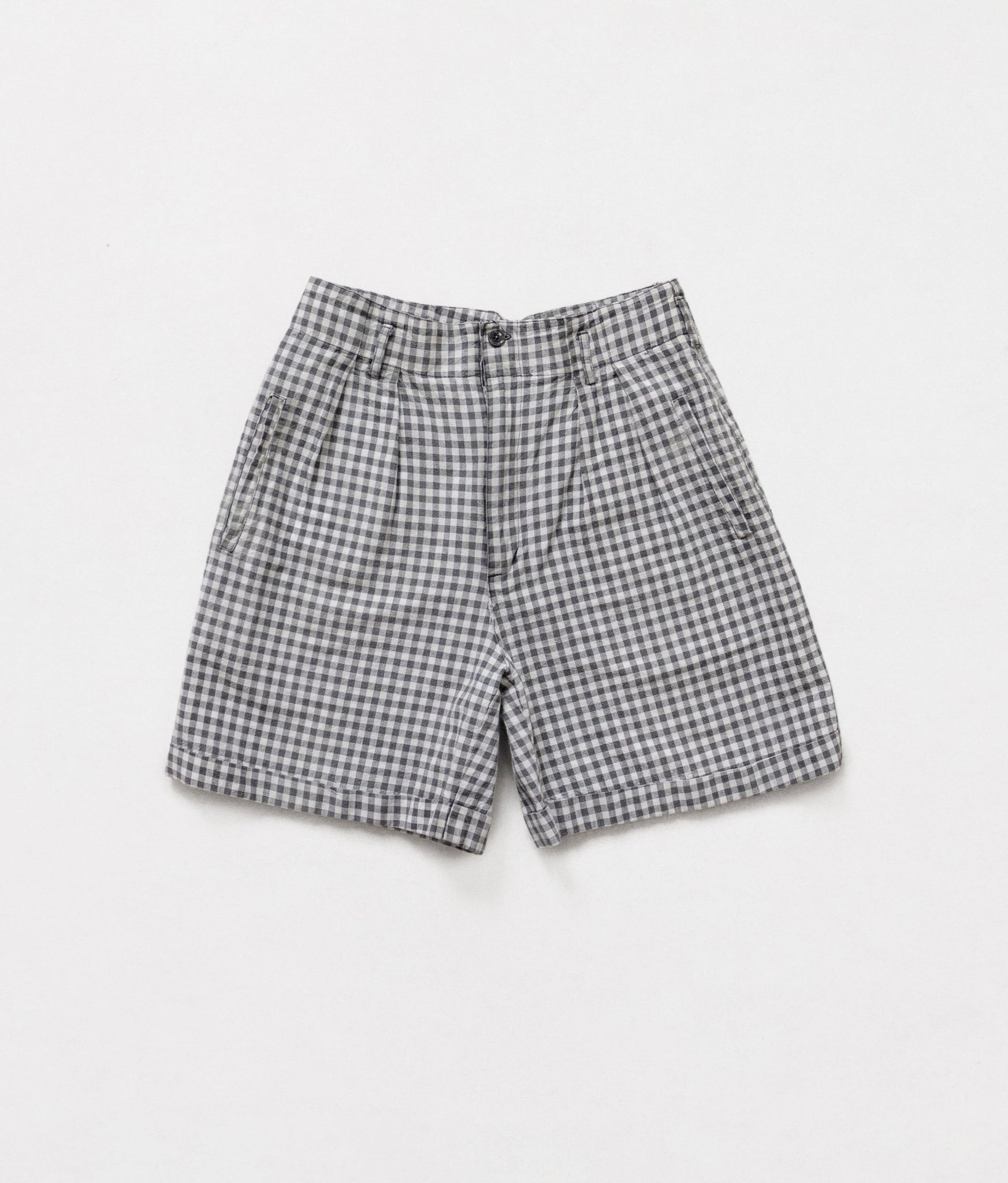 Vintage high-waisted longline shorts with a gingham pattern, pleated front waistline, side and back pockets, zipper and button fly.