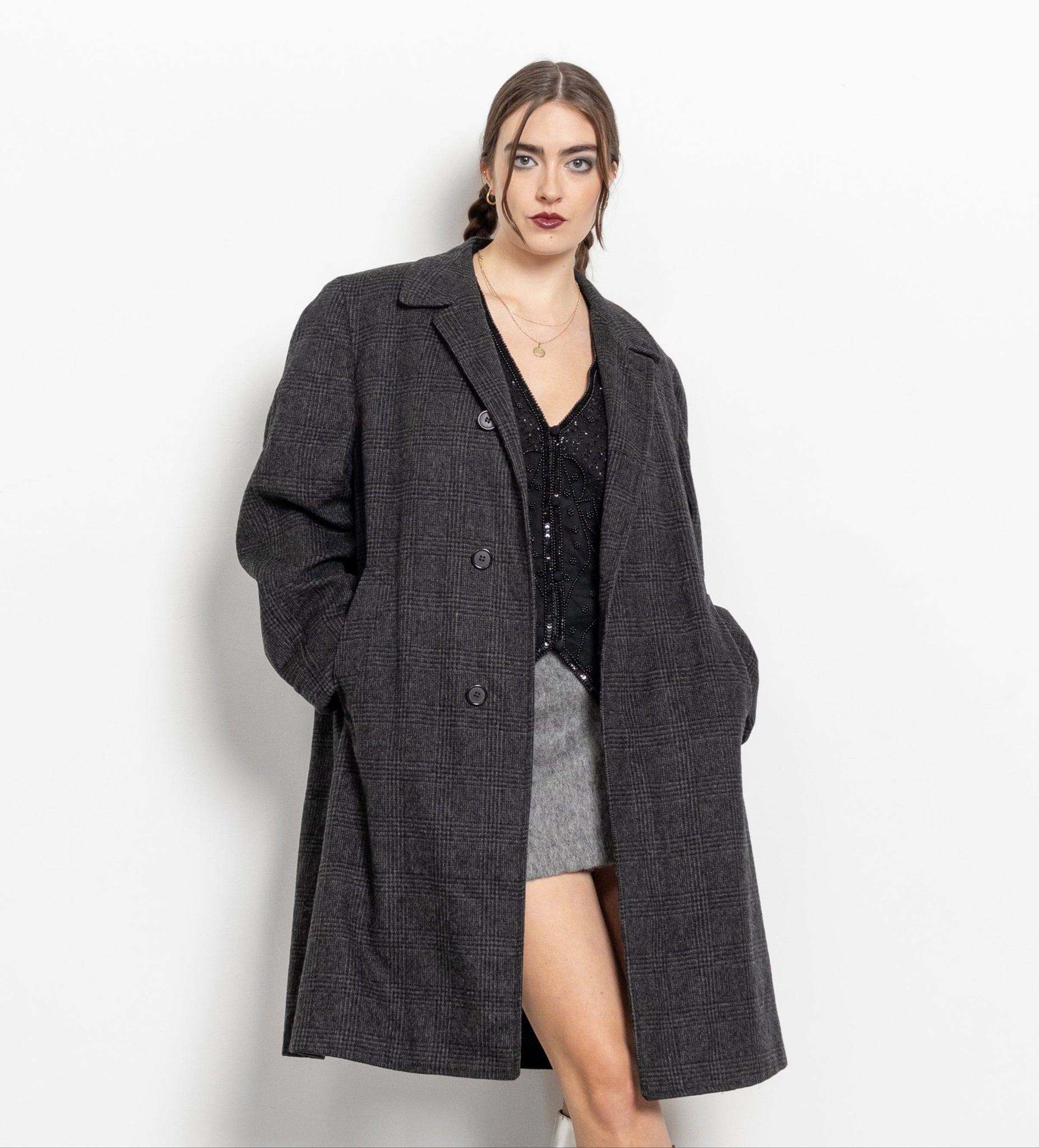 Woman wearing a gray coat on a white background