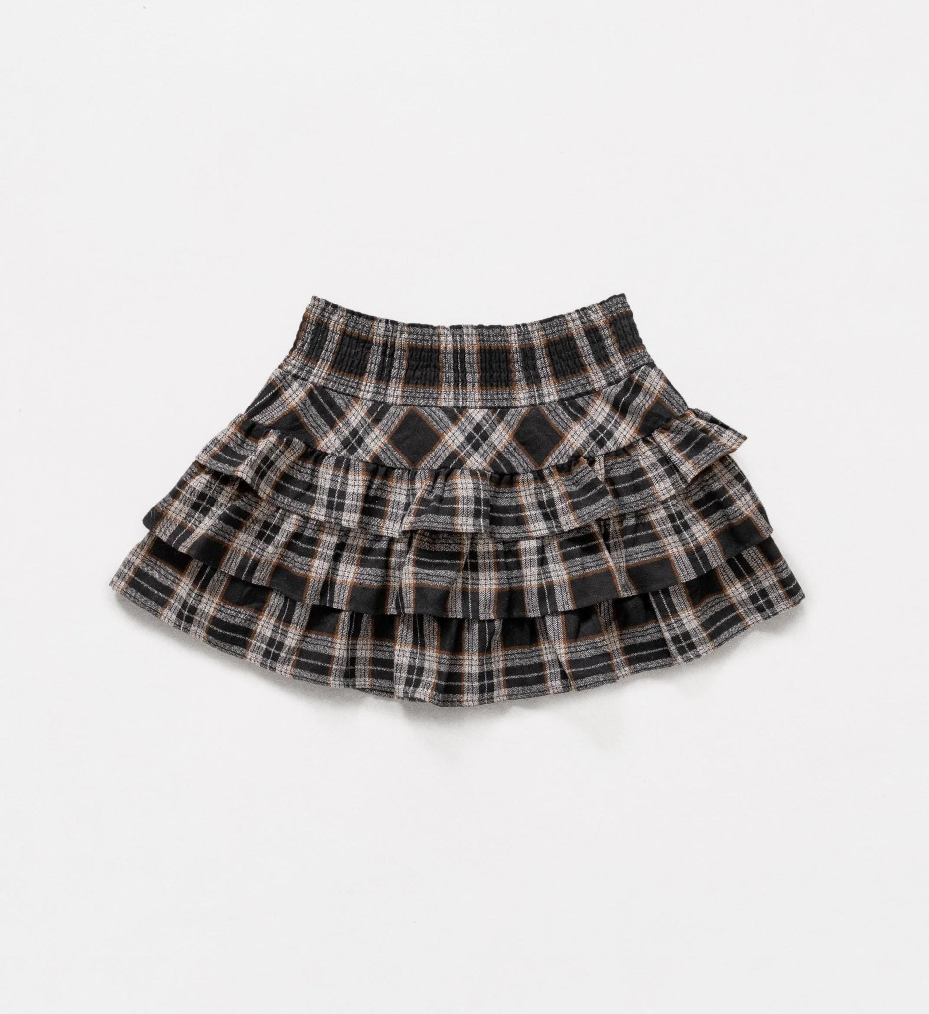 Plaid skirt with ruffled layers on a white background