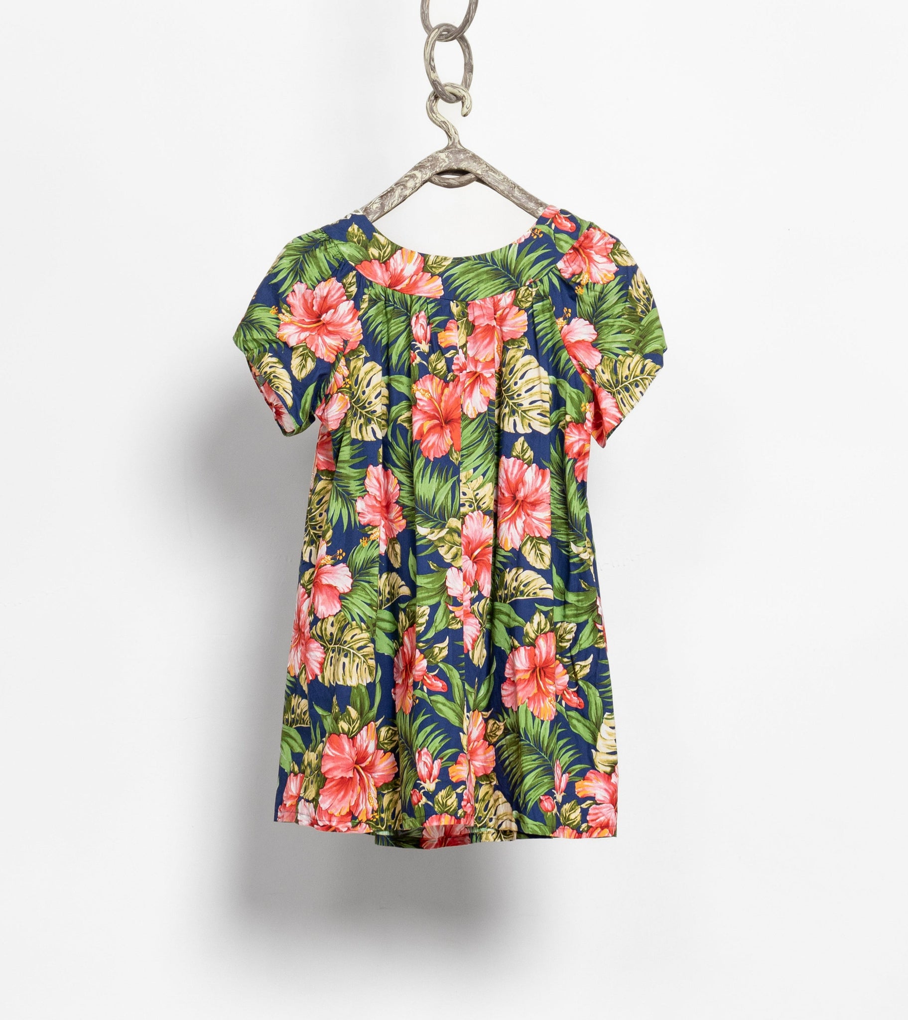 Floral dress hanging on a white background
