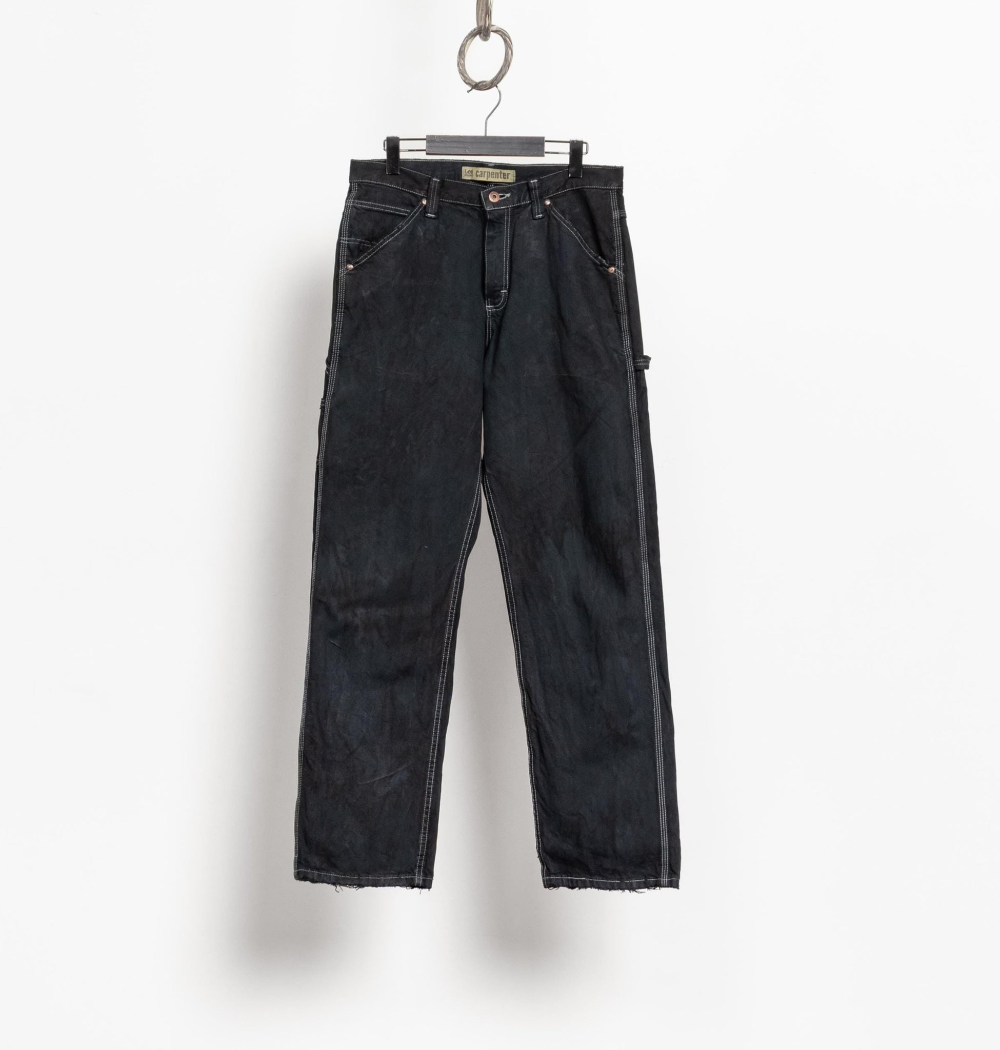 Black jeans hanging on a white background