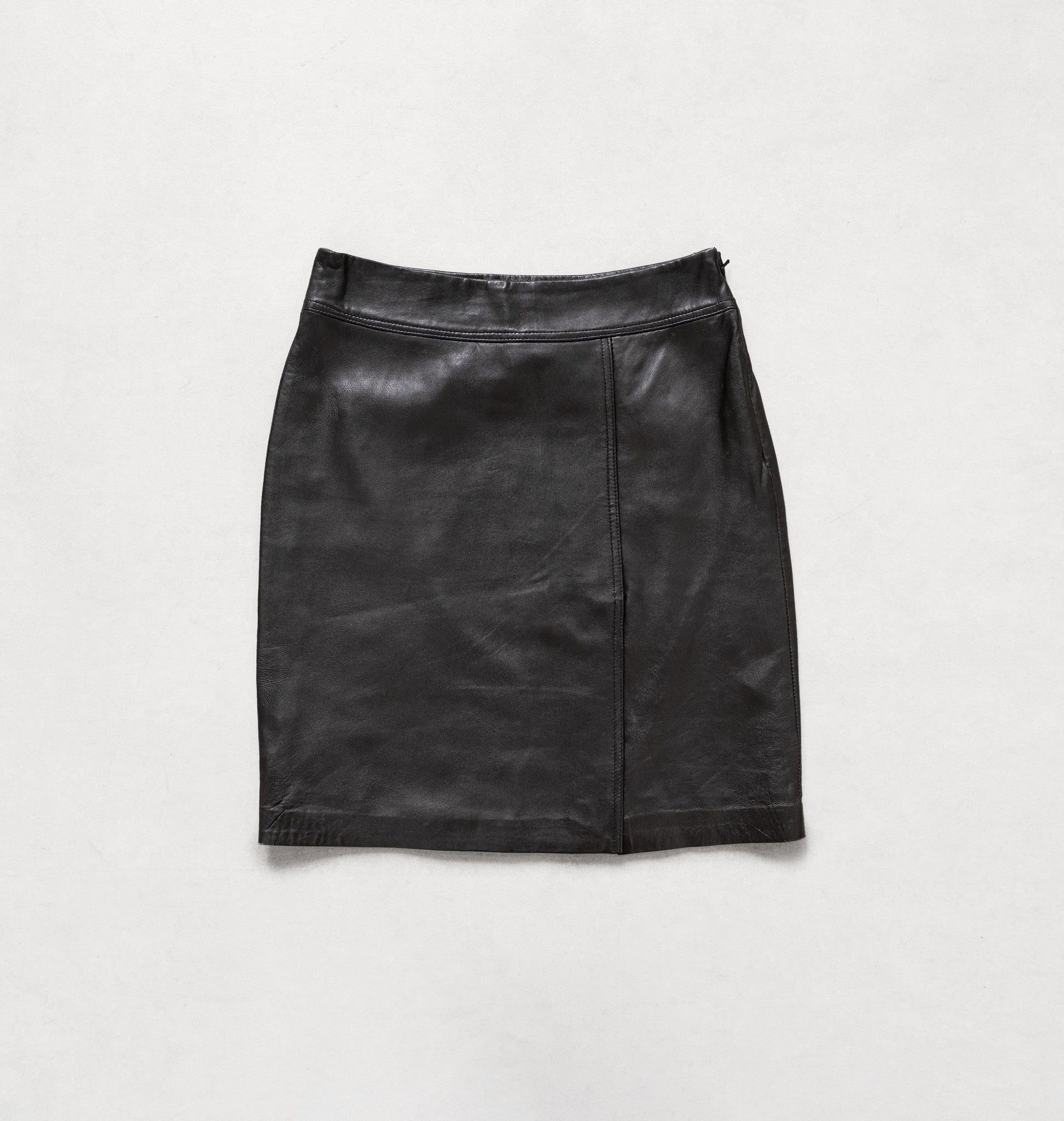 Black leather skirt on a light gray background