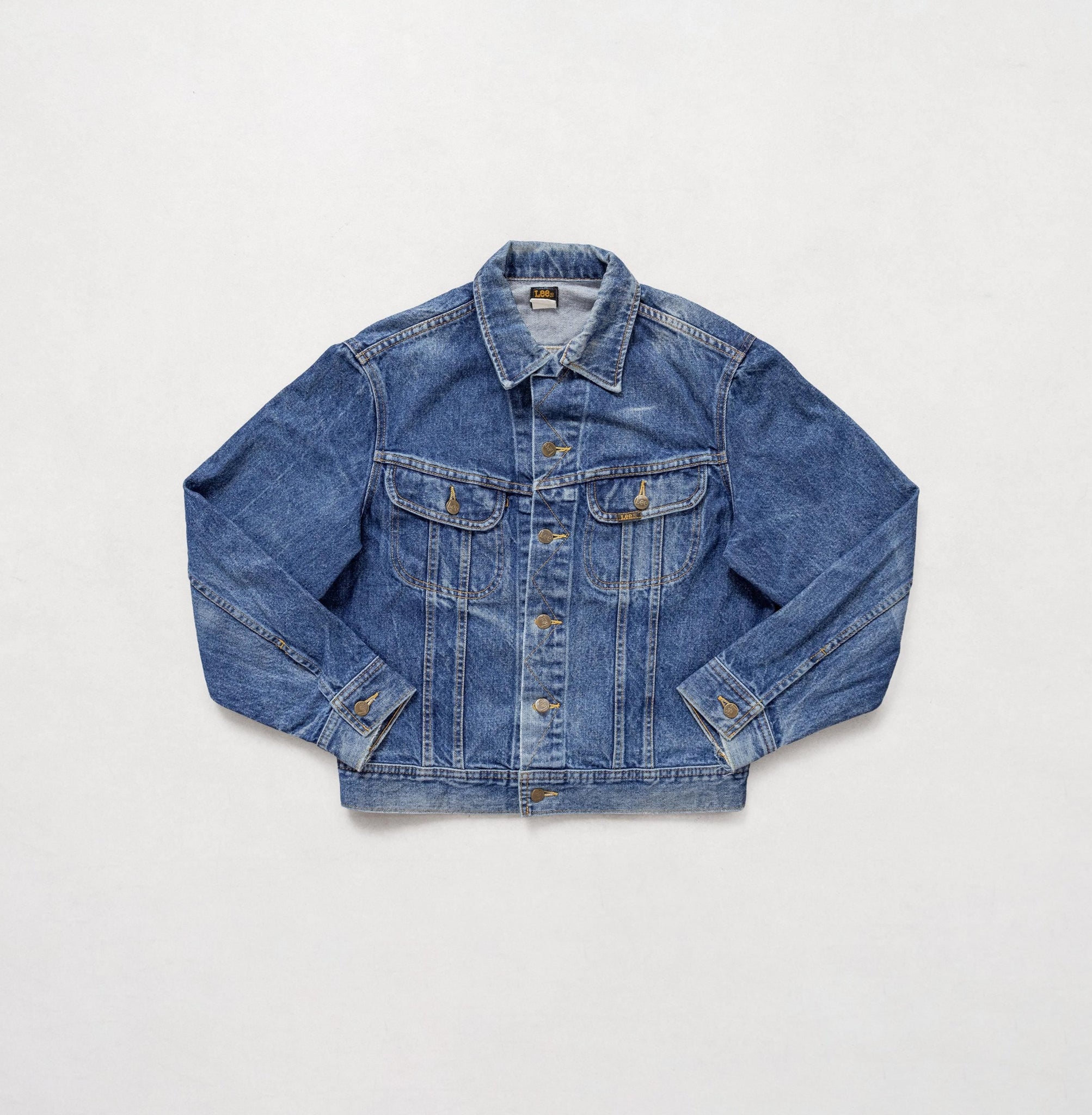 Blue denim jacket on a light gray background
