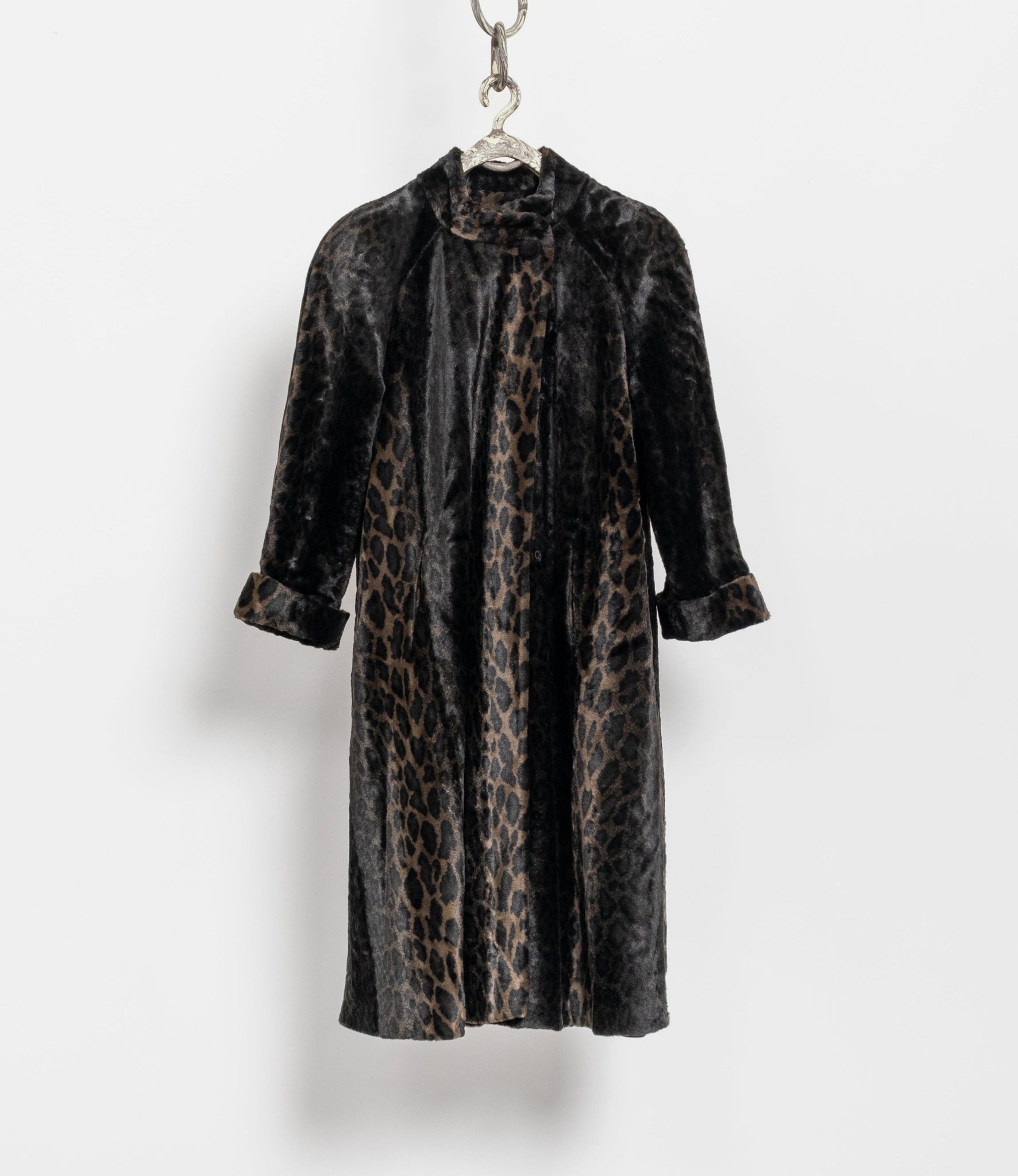 Leopard print coat on a hanger against a white background