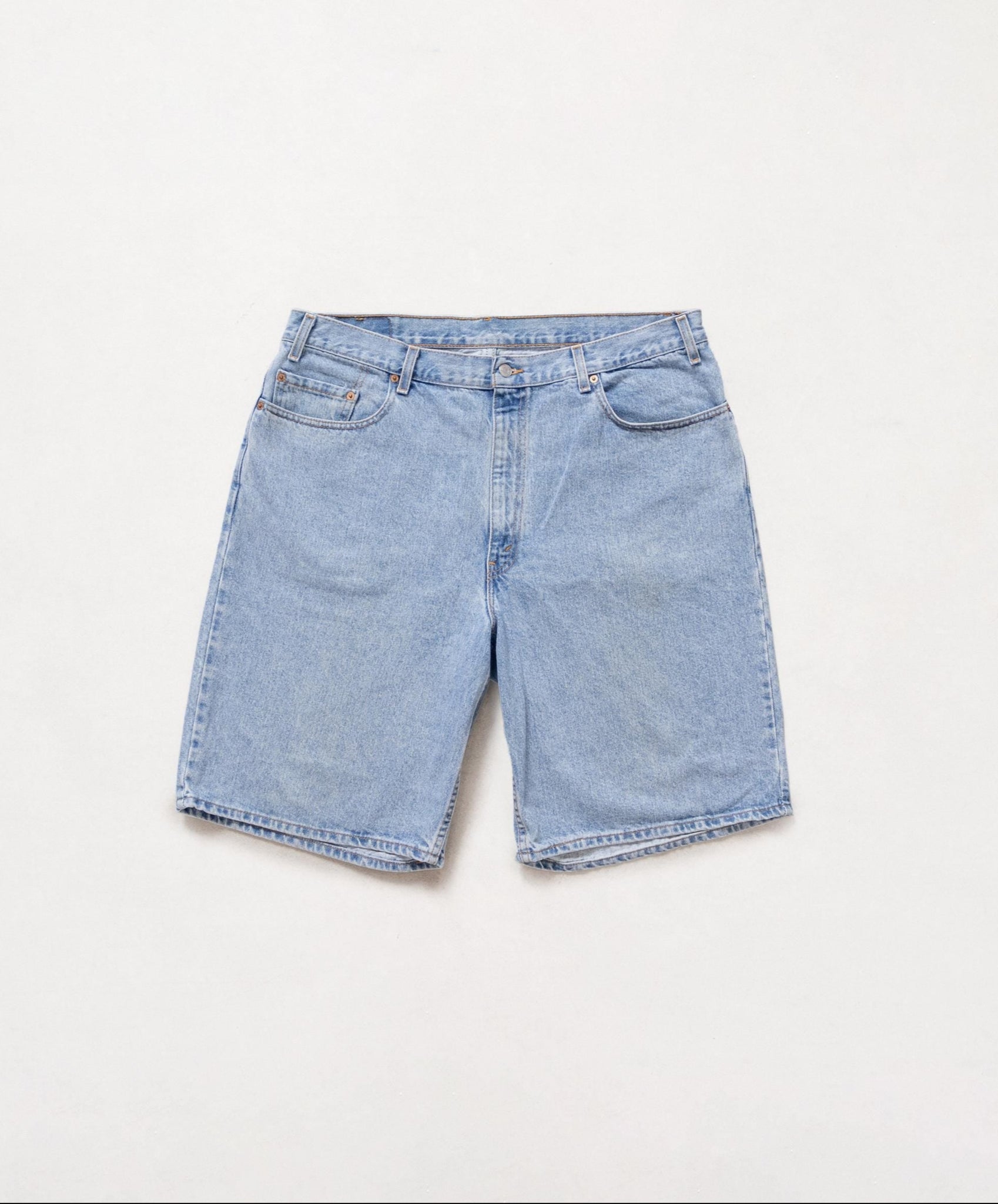 Light blue denim shorts on a white background