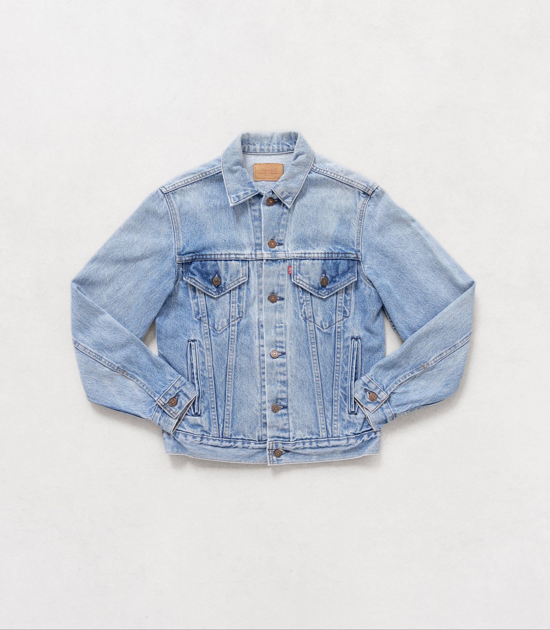 Light blue denim jacket on a white background