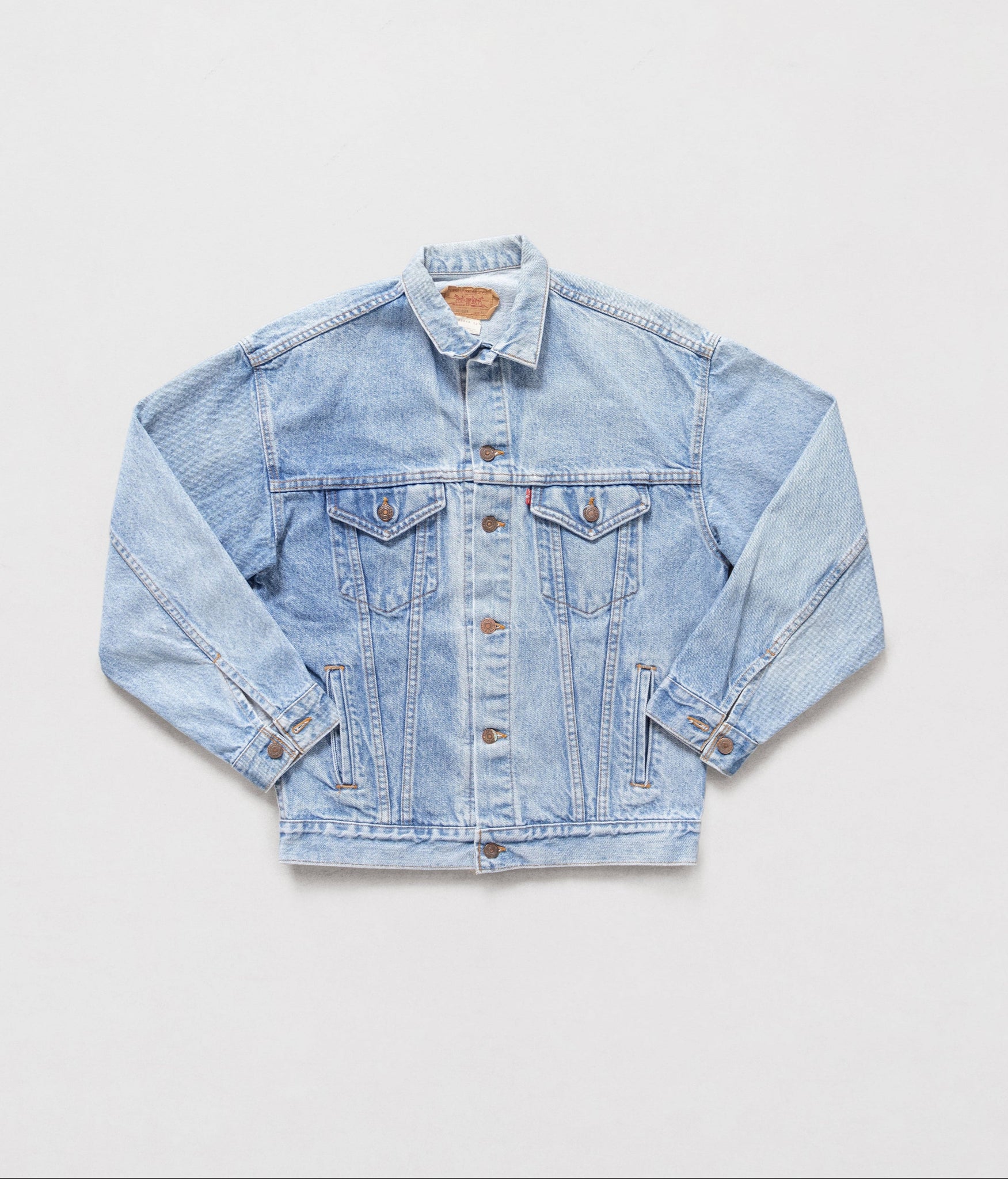 Light blue denim jacket on a white background