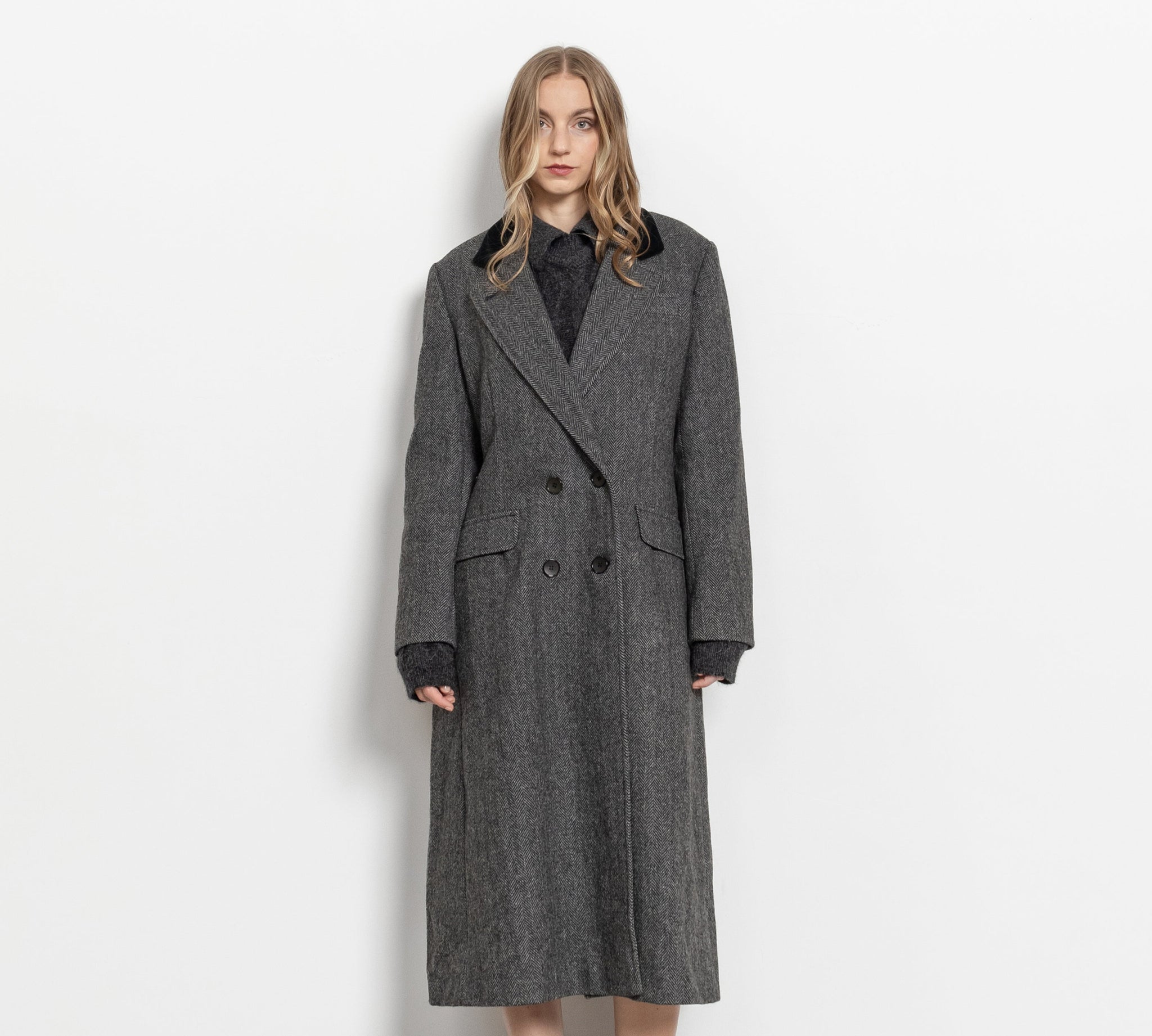 Woman wearing a gray coat on a white background