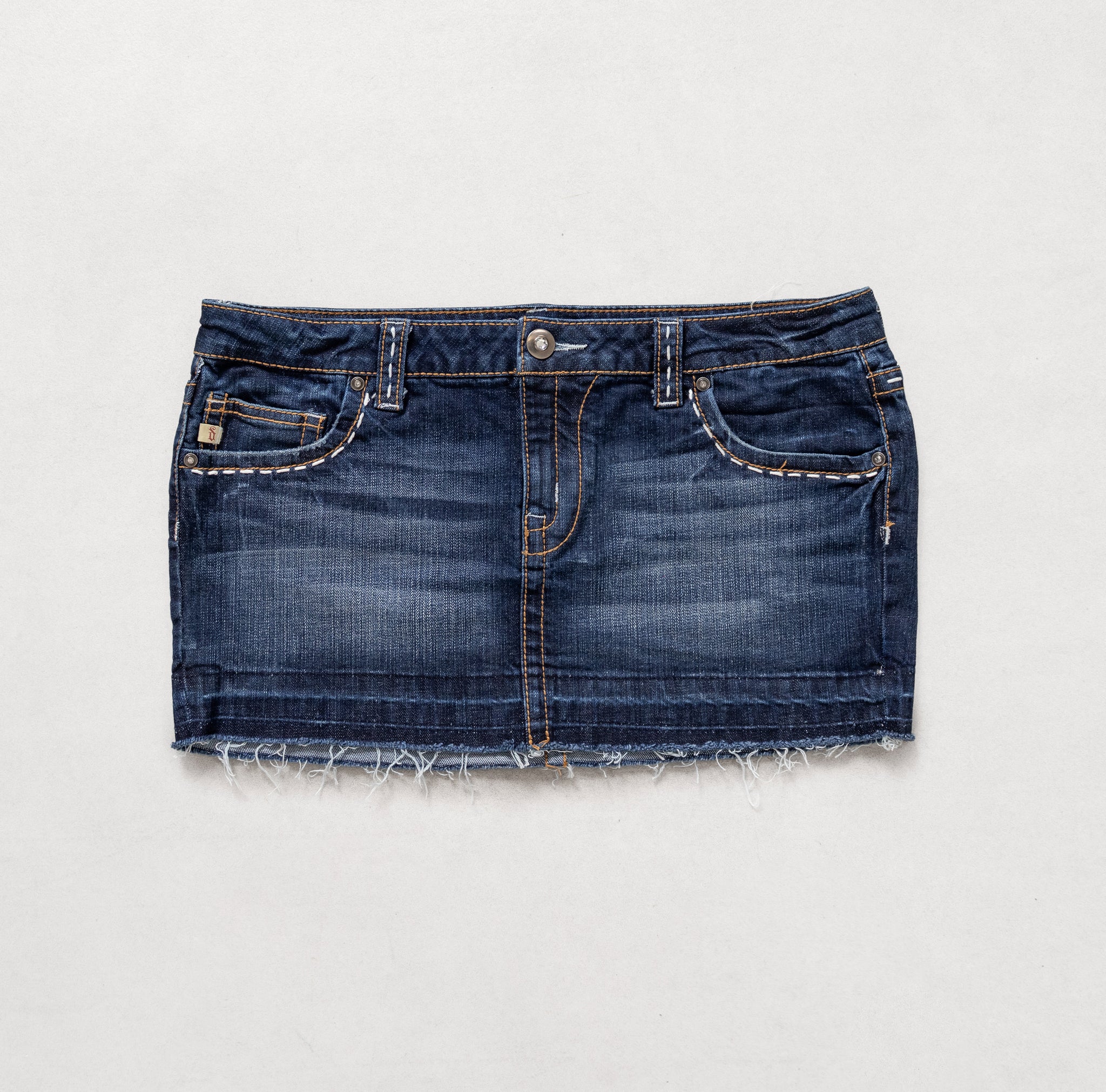Blue denim skirt on a light gray background