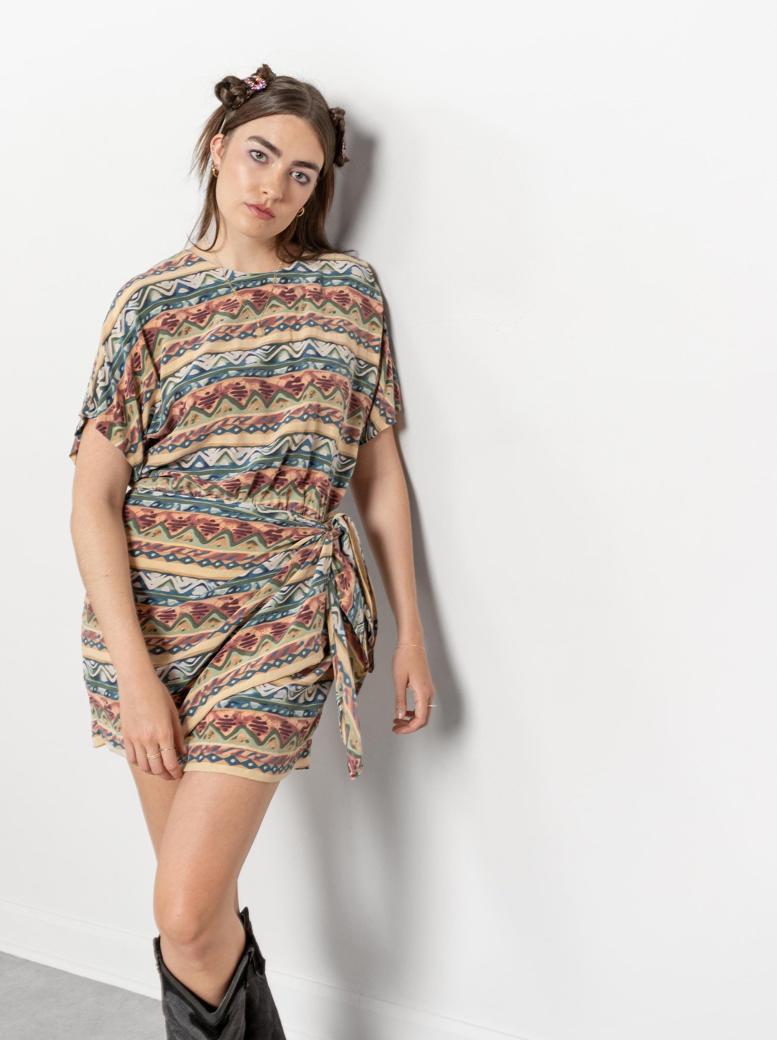Woman wearing a patterned dress against a white background
