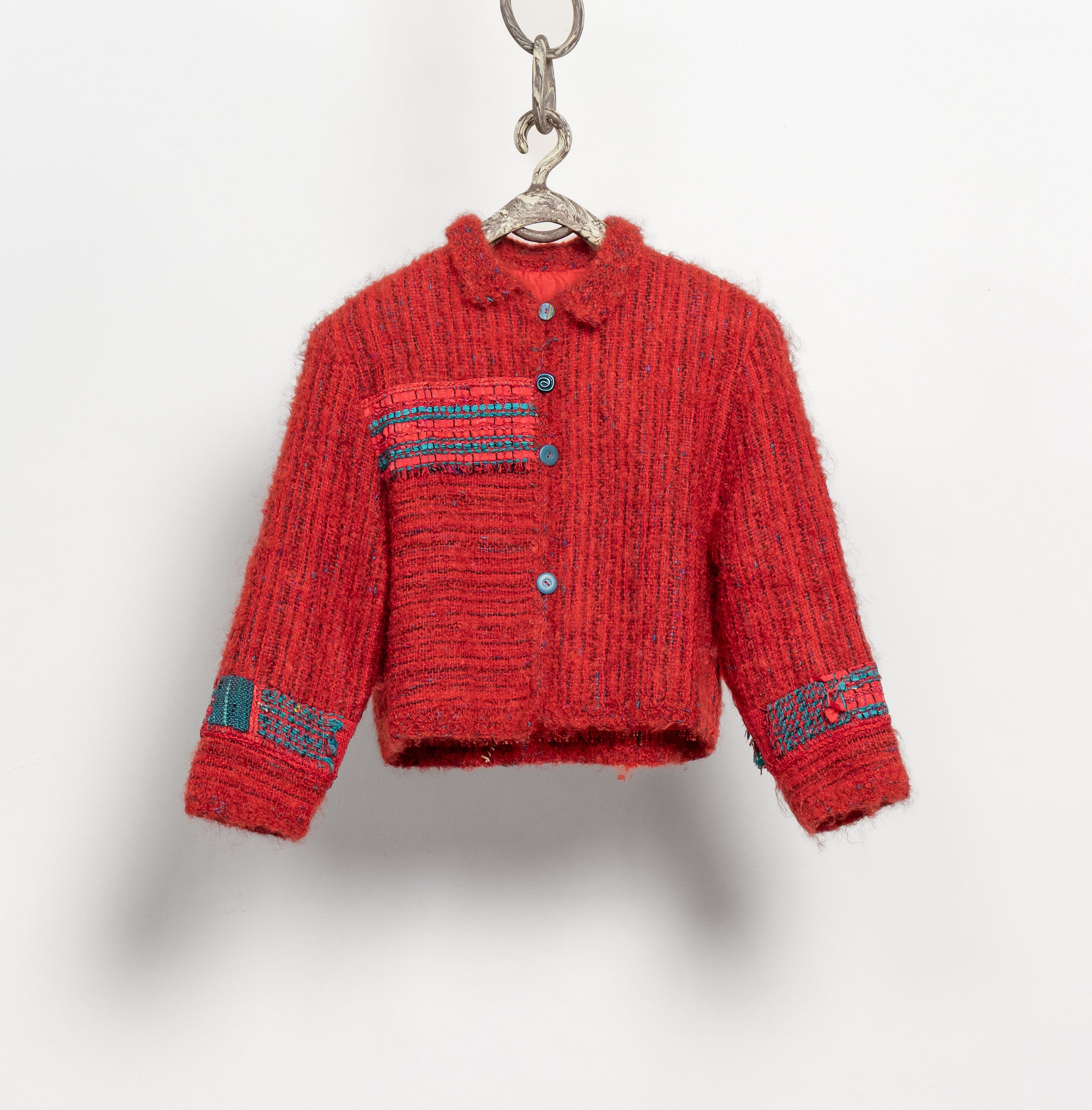 Red textured jacket with patterned sleeves on a white background