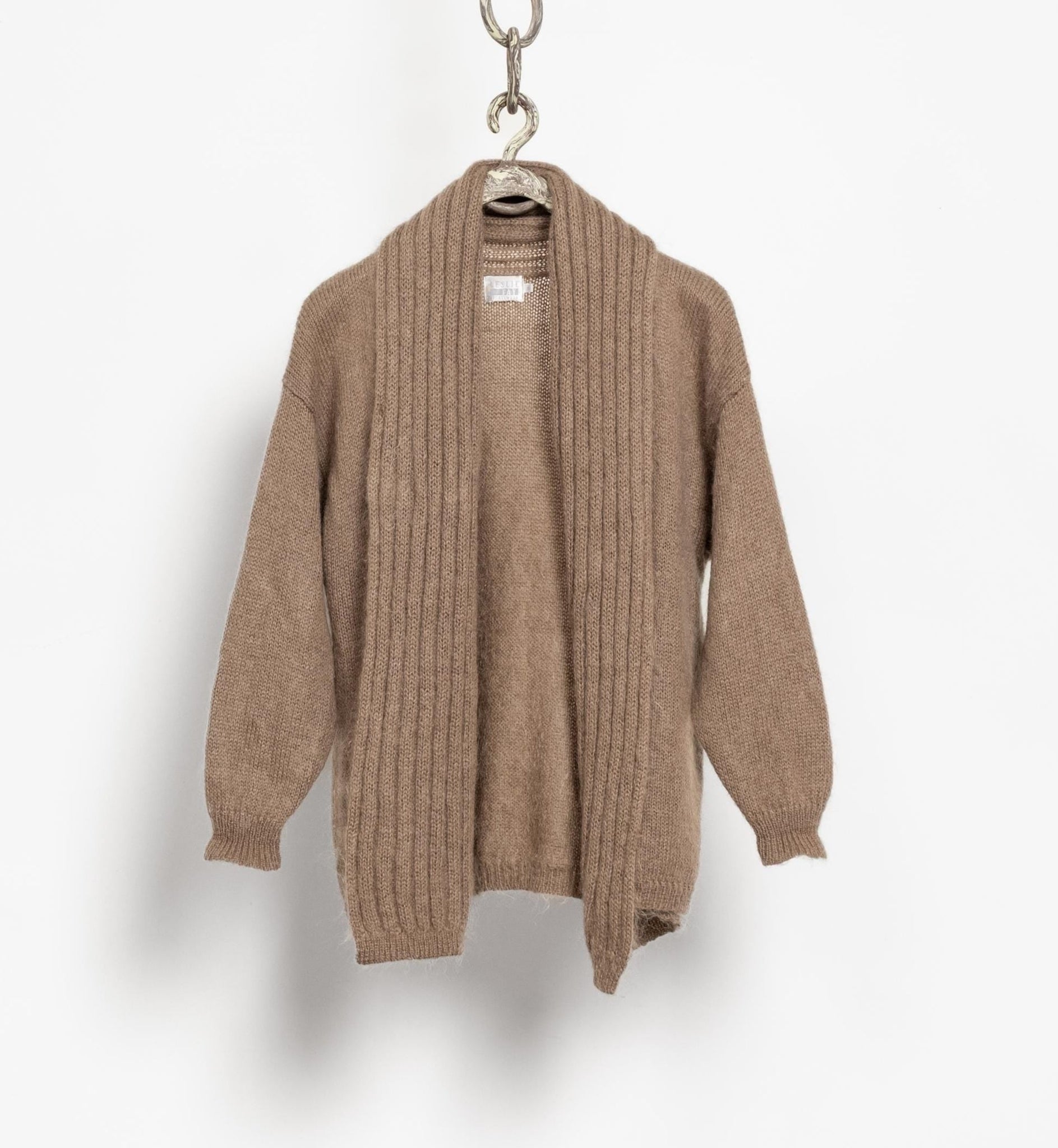 Brown cardigan hanging on a white background