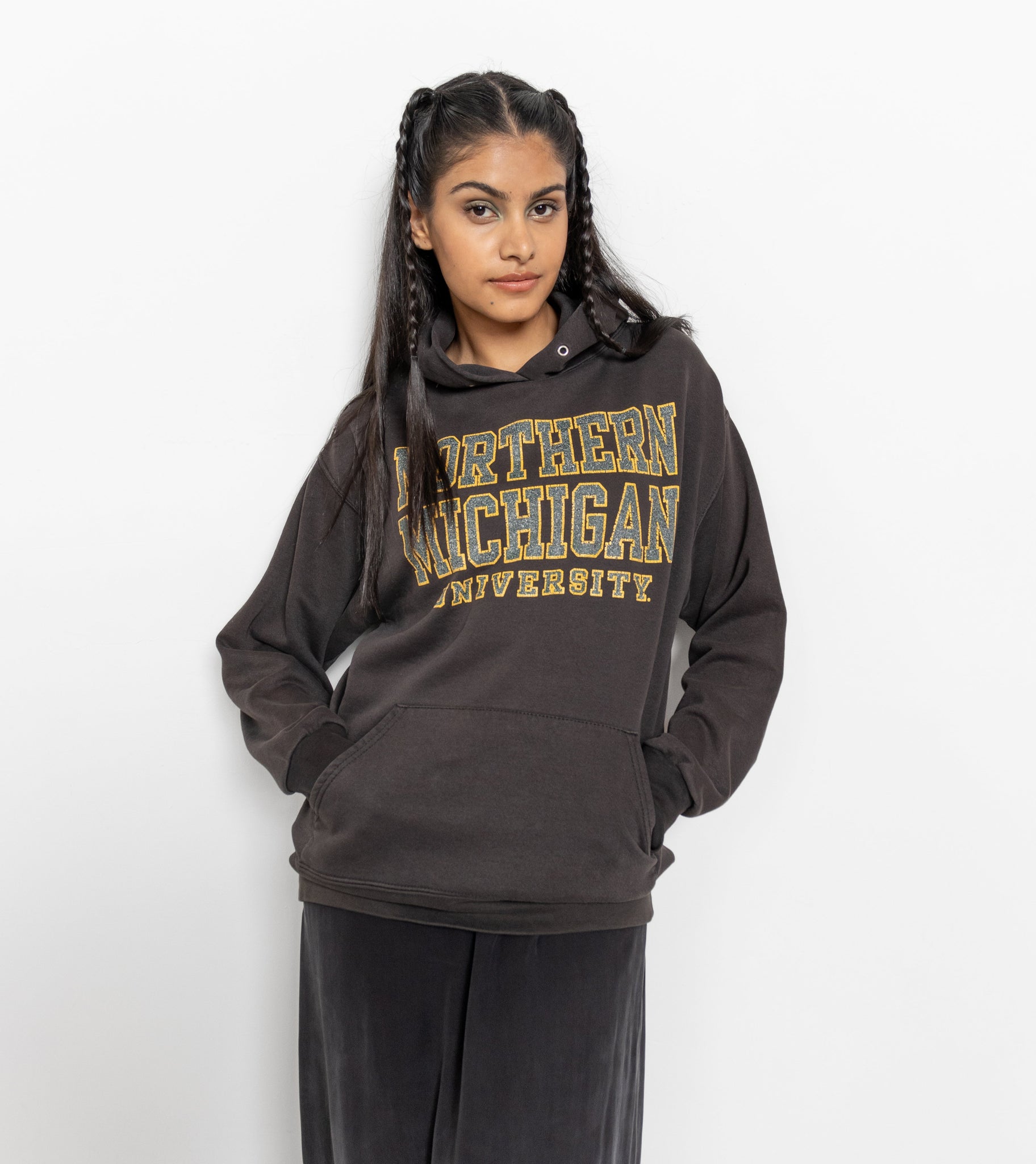 A person wearing a black hooded sweatshirt with 'Northern Michigan University' text in yellow.