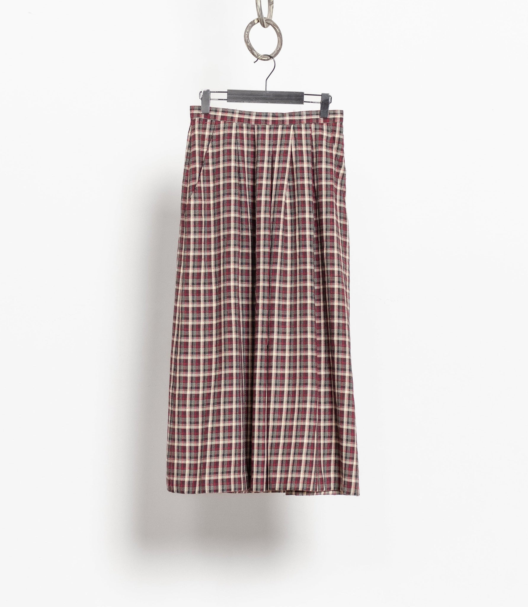 Plaid skirt hanging on a white background