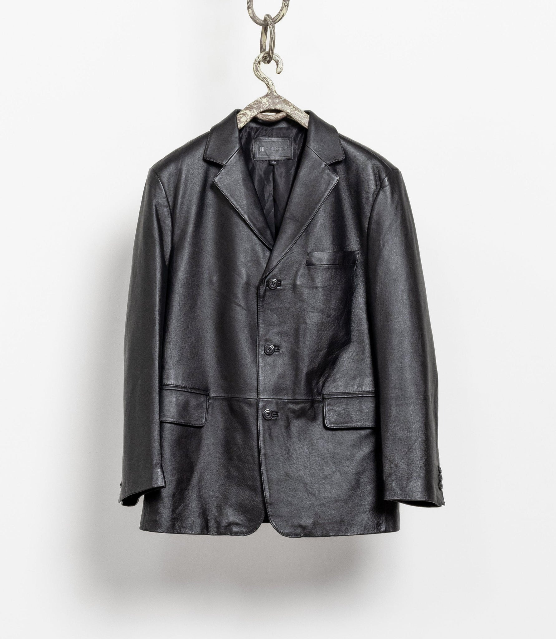 Black leather jacket hanging on a white background