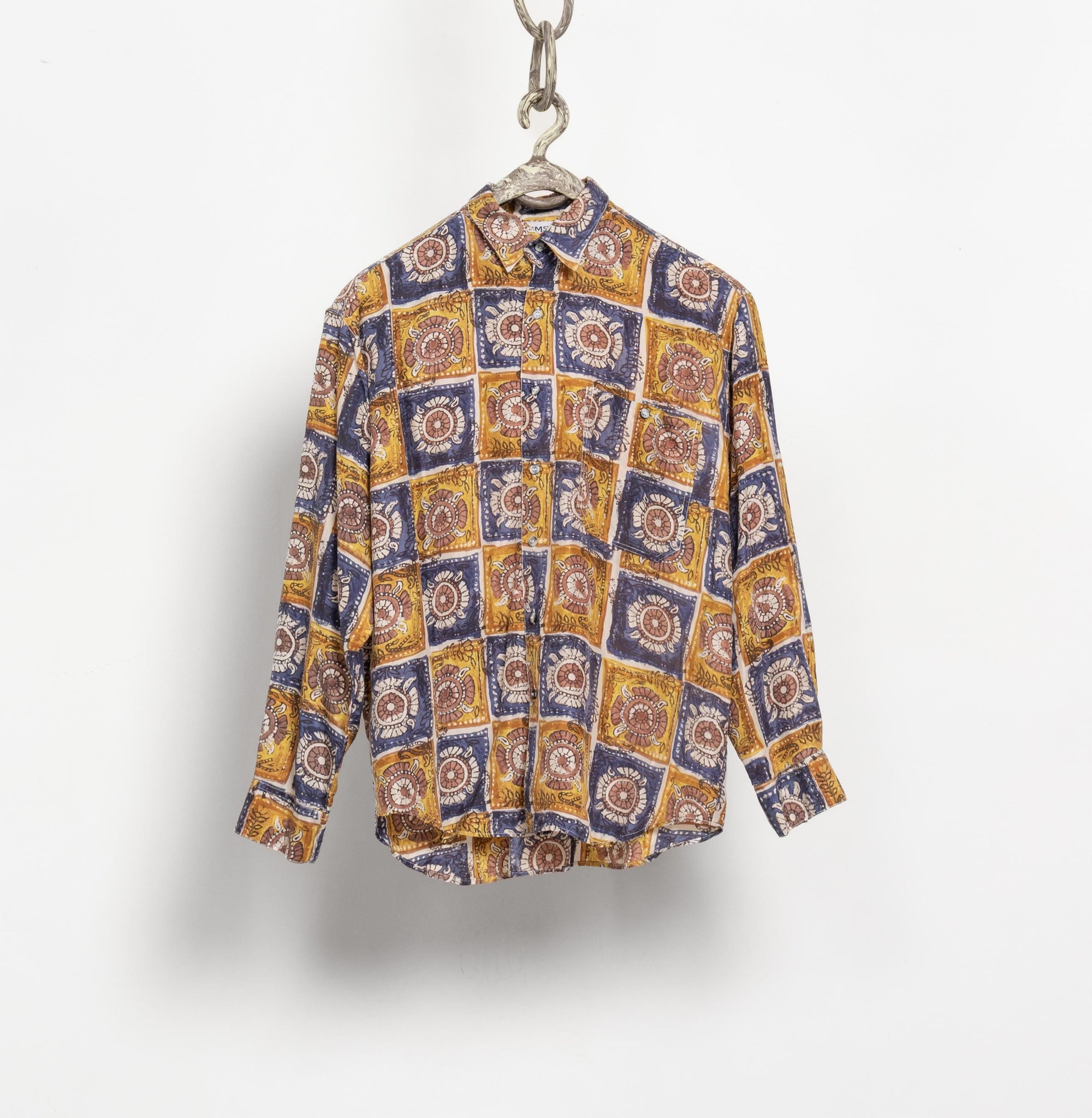 Patterned shirt hanging on a white background