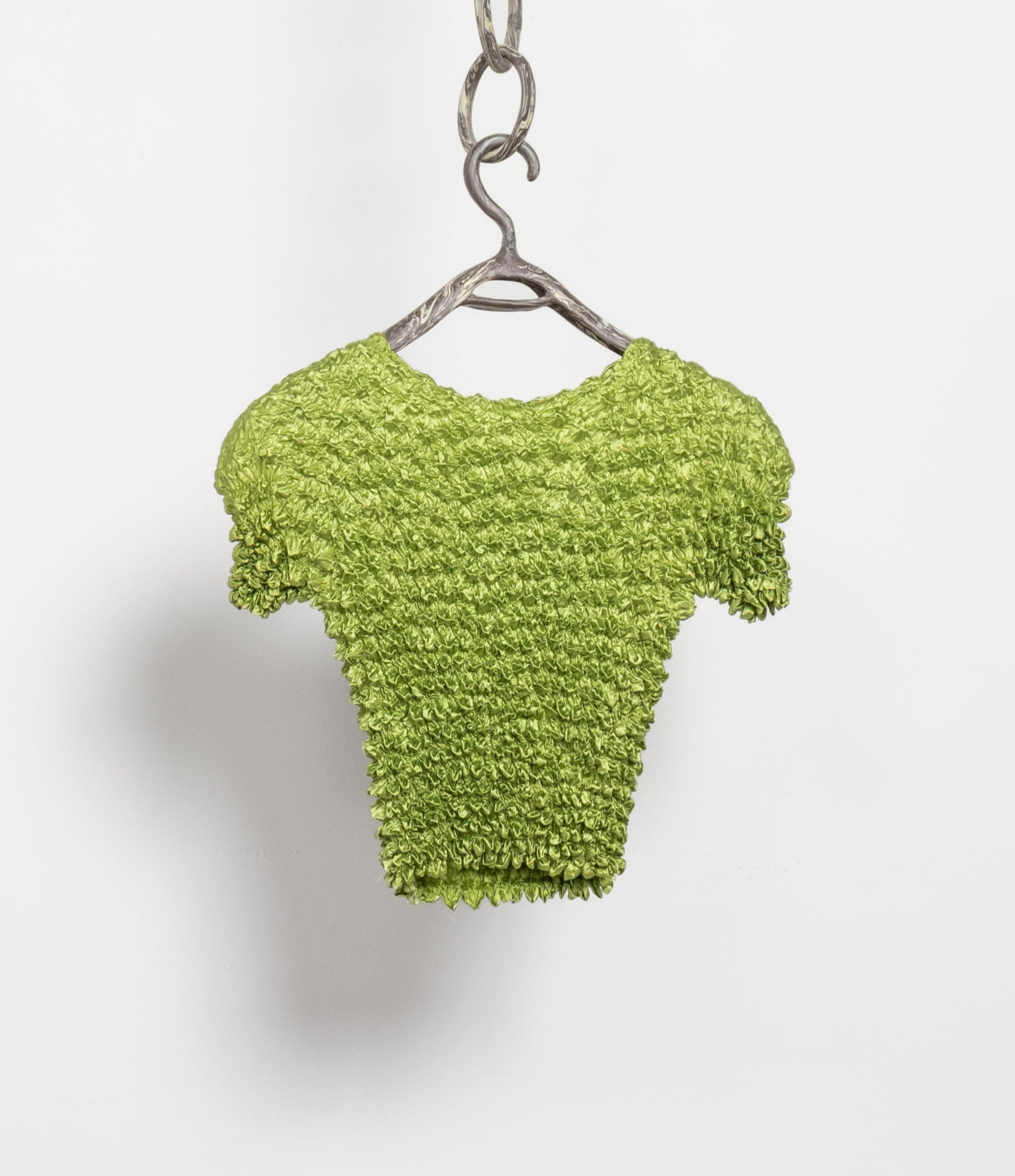 Vintage lime green crinkle popcorn slinky top displayed on a hanger against a white background.