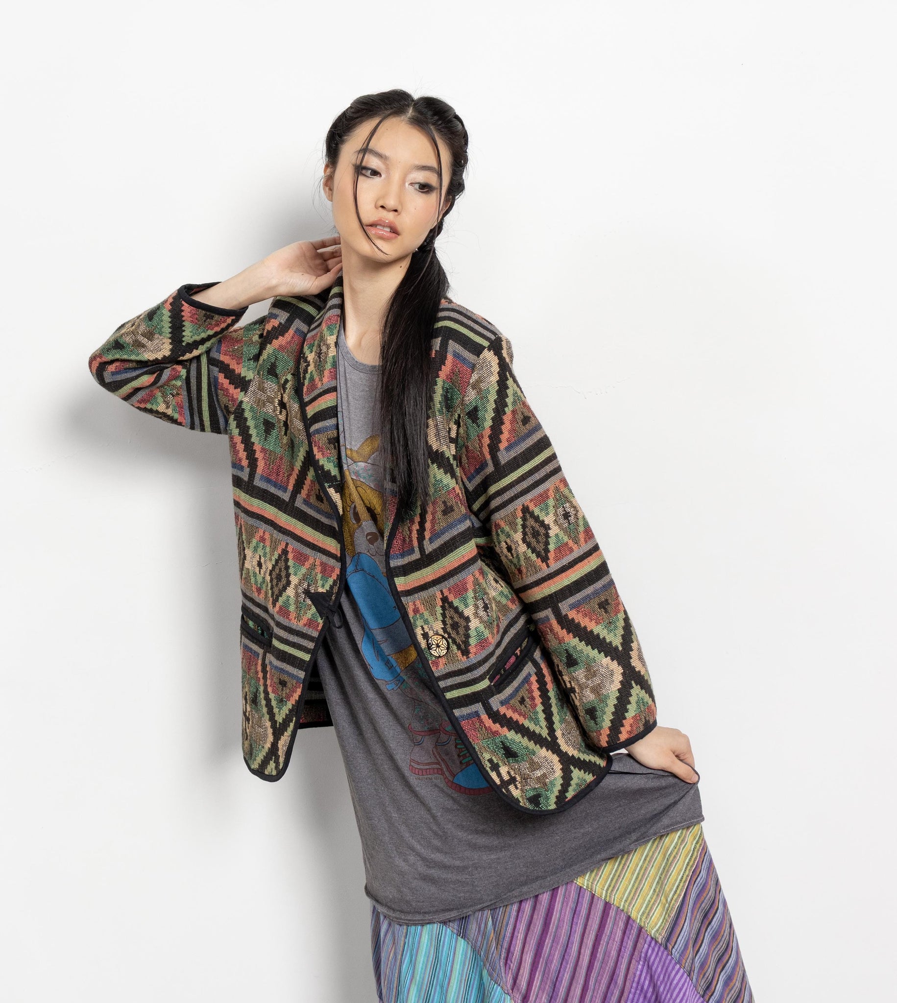 Woman wearing a patterned jacket on a white background