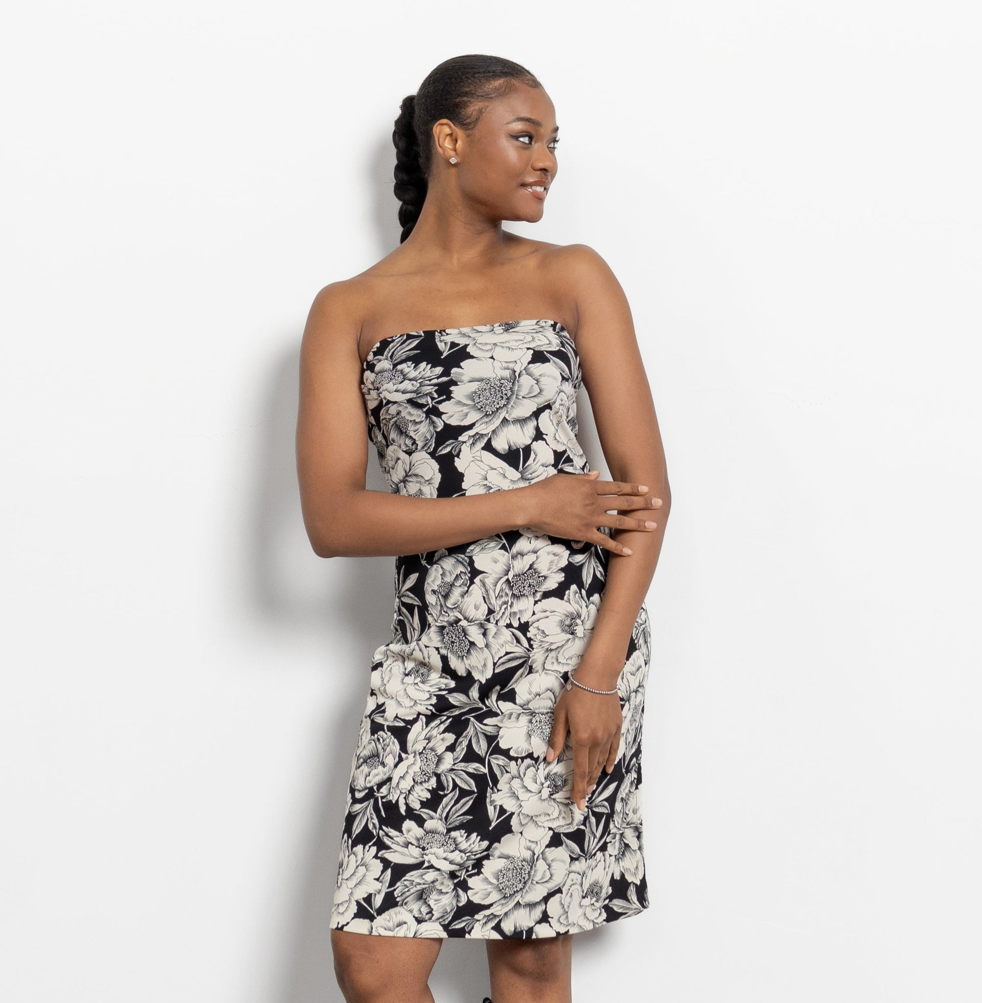 A woman modeling a vintage 90's black and white floral strapless tube dress.
