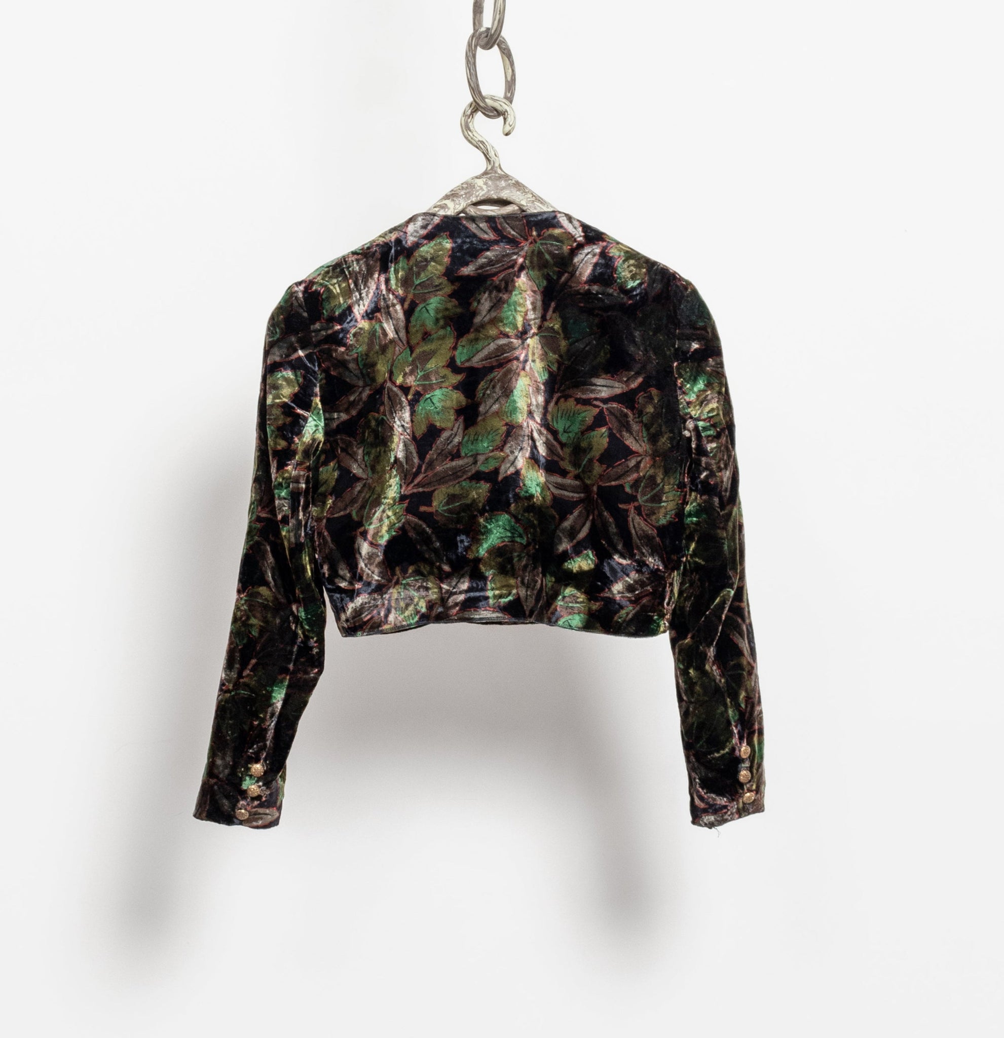 Camouflage-patterned jacket on a hanger against a white background