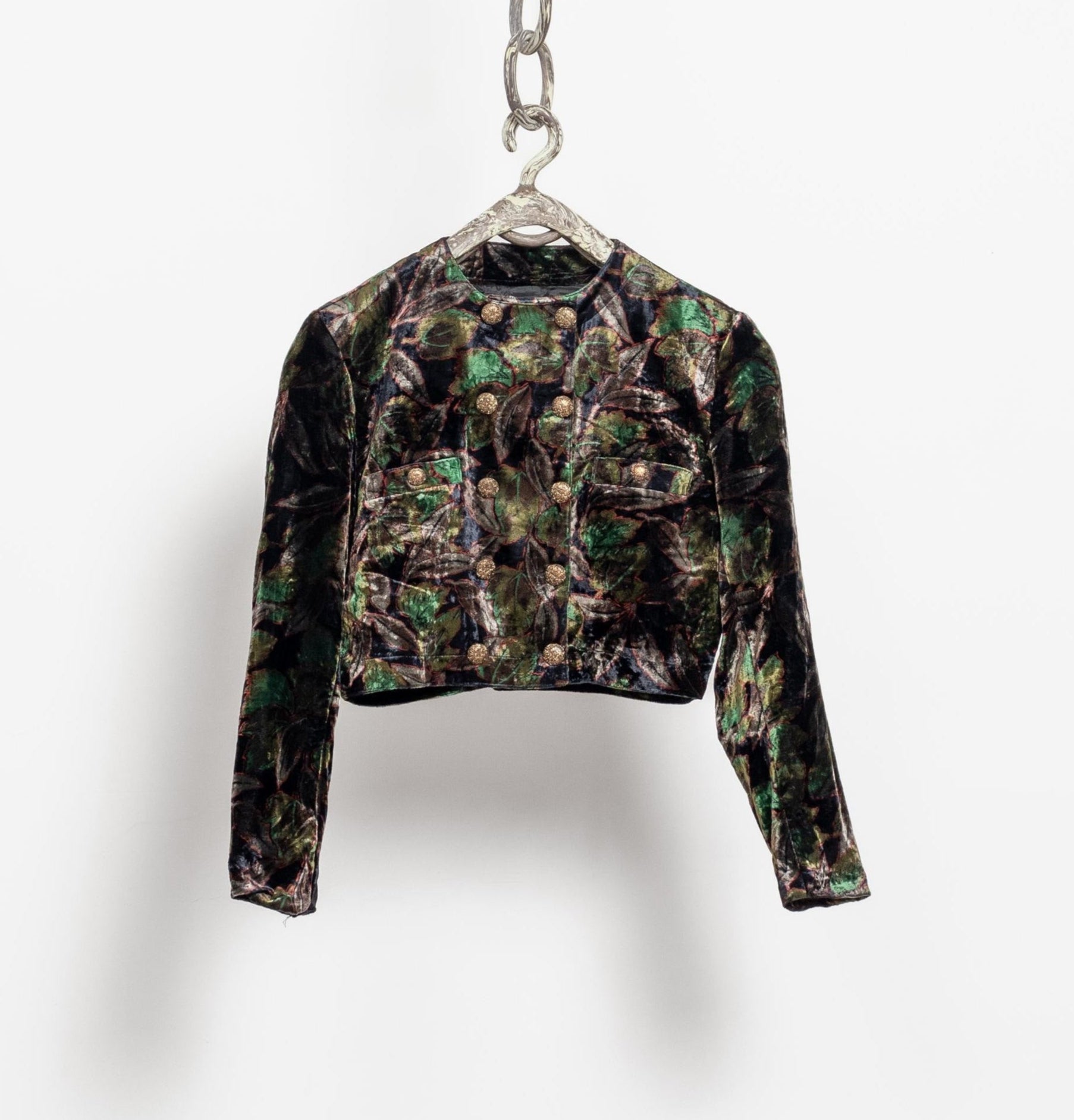 Camouflage-patterned jacket on a hanger against a white background