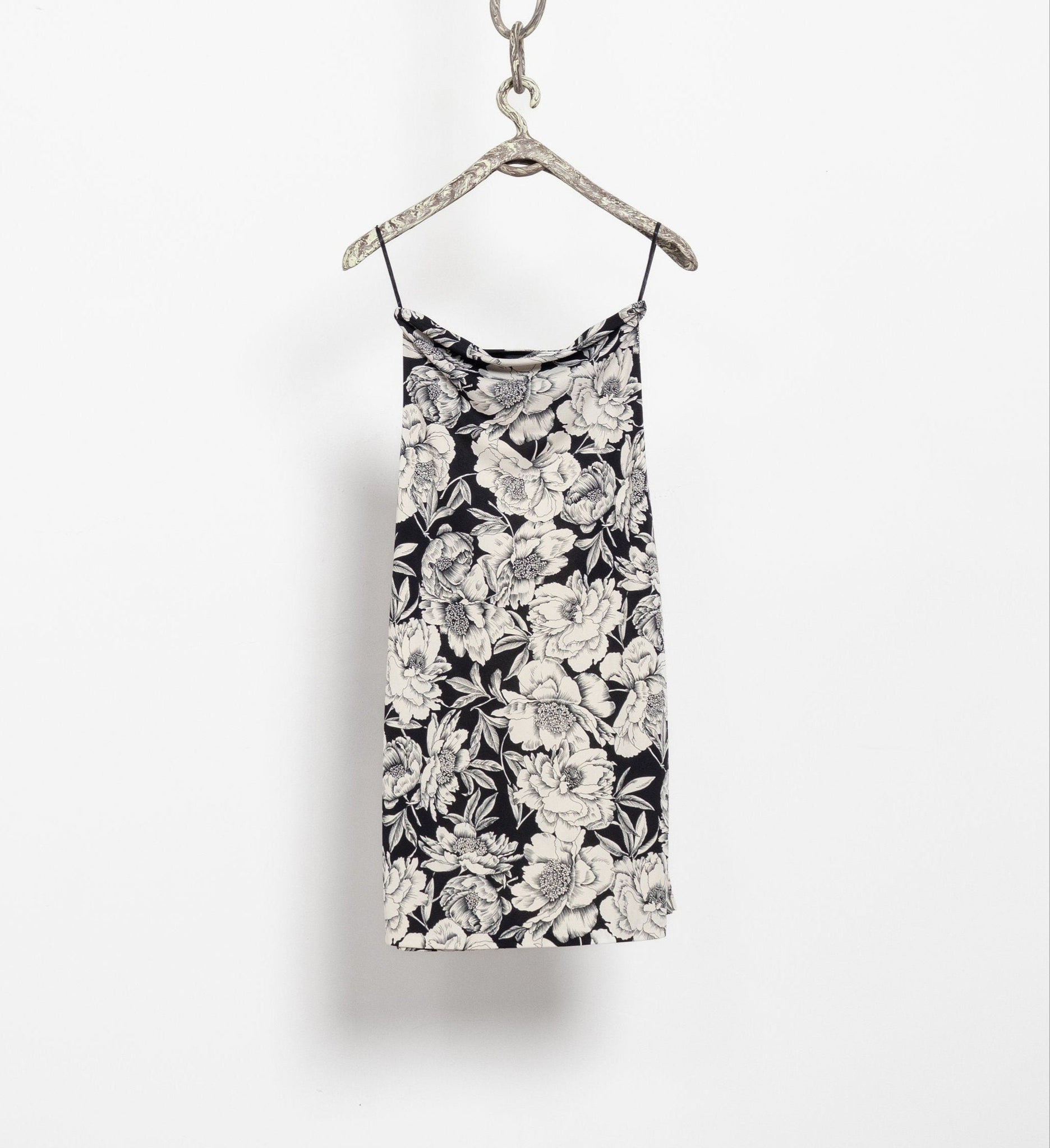 Vintage 90's black and white floral strapless tube dress hanging on a hanger against a white background.