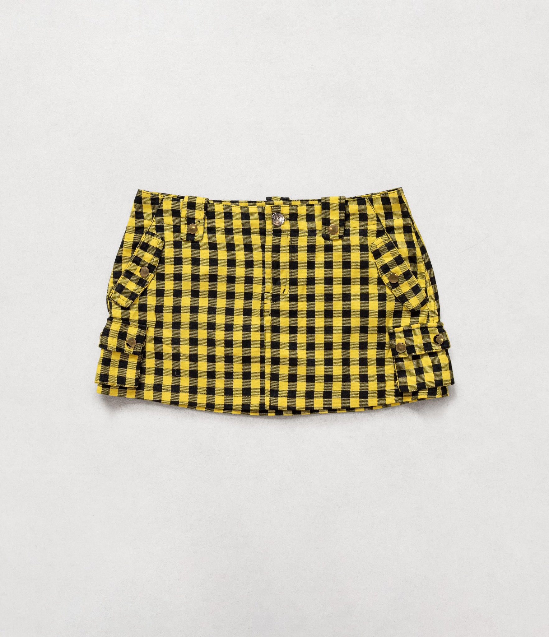 Yellow and black checkered skirt on a light gray background