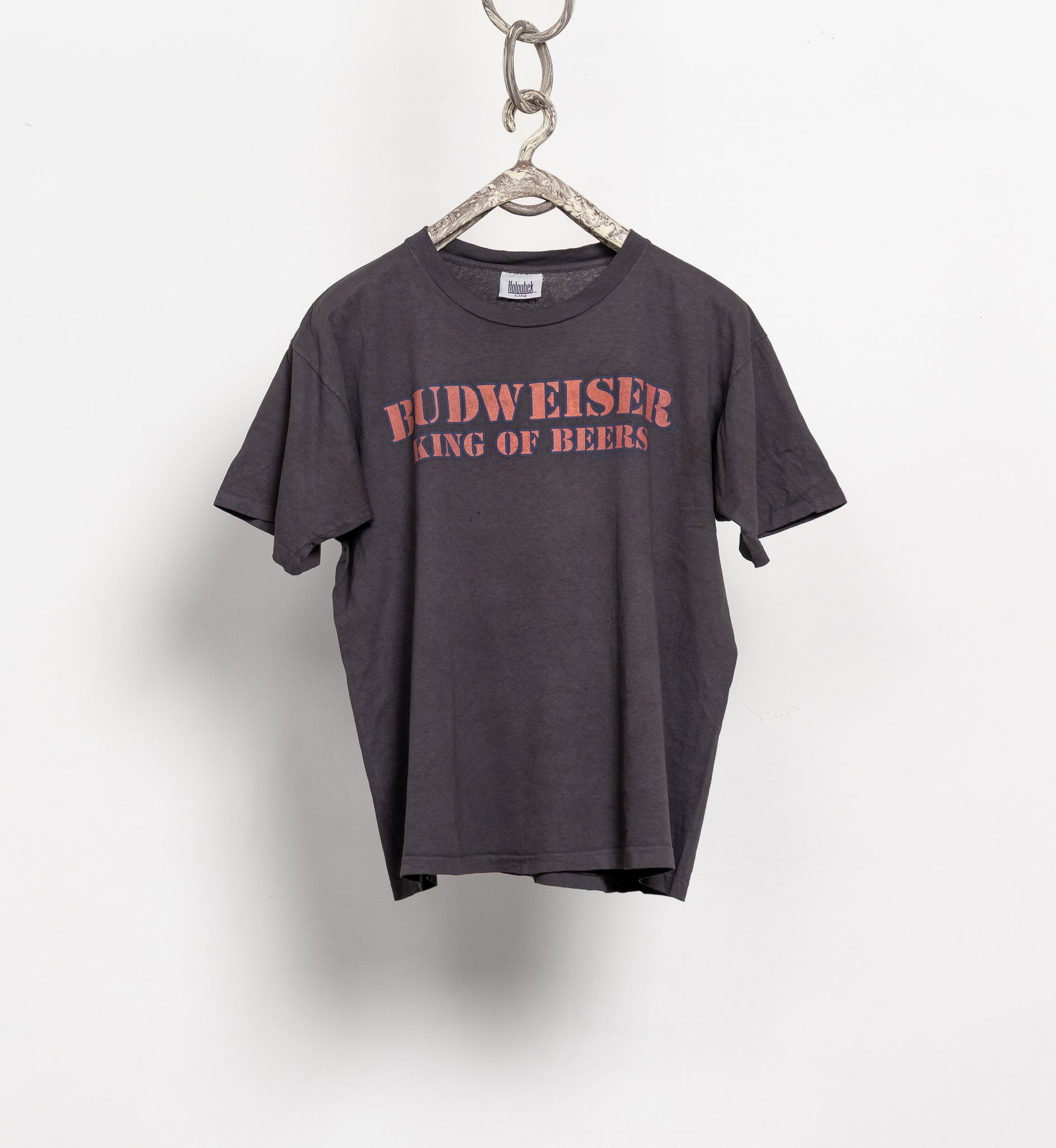 Gray t-shirt with 'Budweiser King of Beers' text on a hanger against a white background