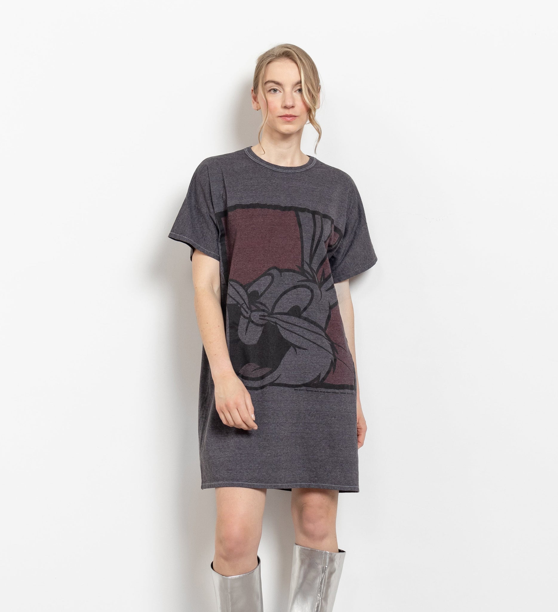 A woman modeling a long black graphic t-shirt with a large printed Bugs Bunny design in red and white.