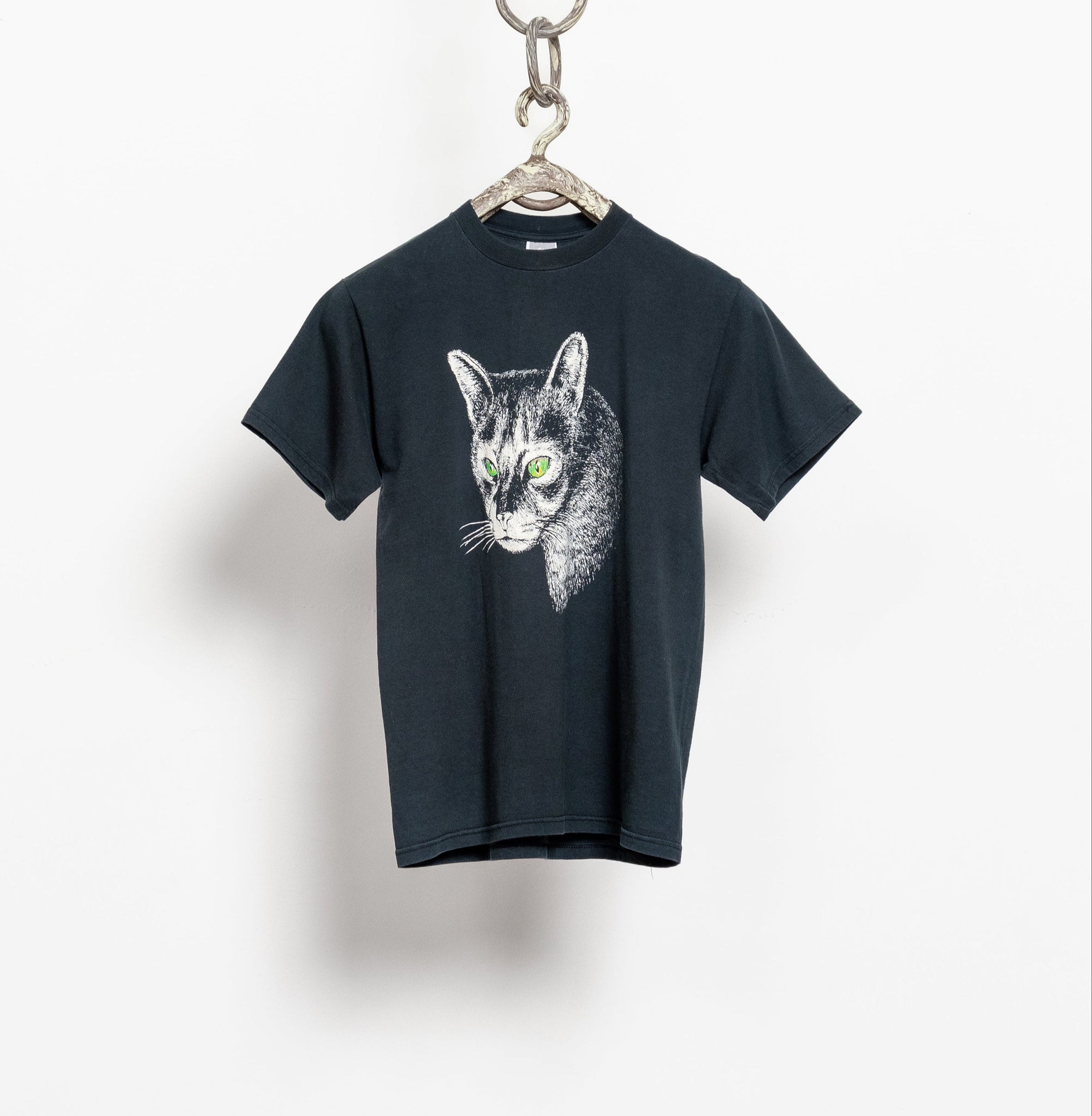 Black t-shirt with a cat graphic on a white background