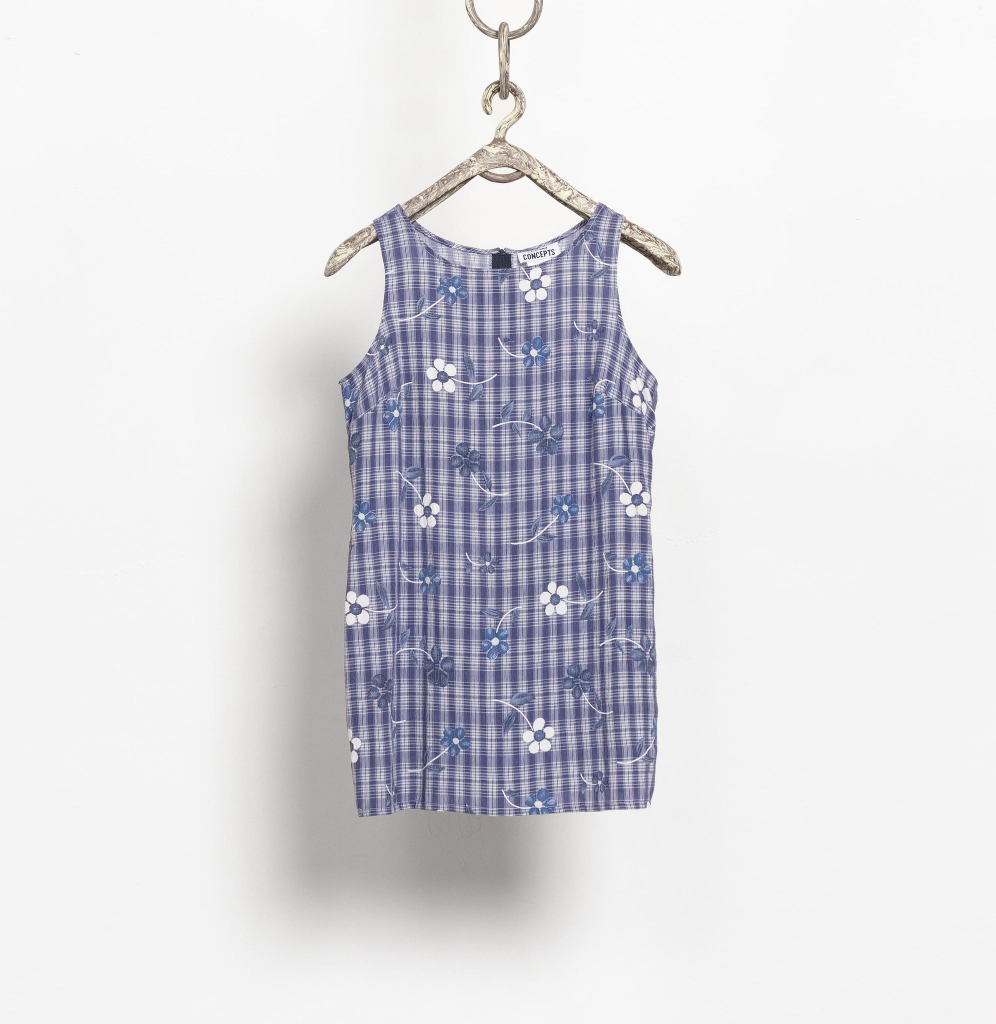 Blue checkered dress with floral pattern on a hanger against a white background