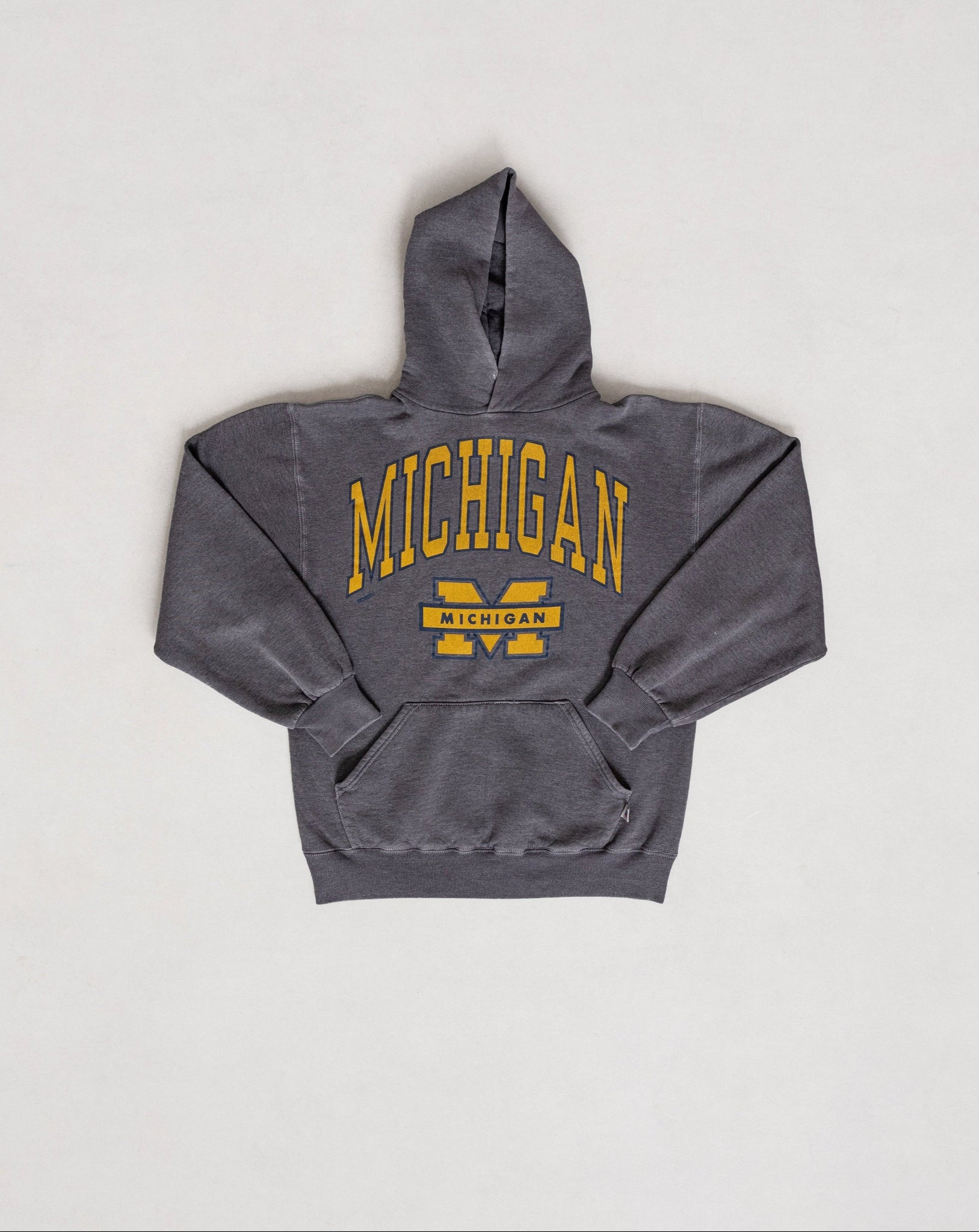 A vintage gray Michigan University sweatshirt with yellow lettering on the front.