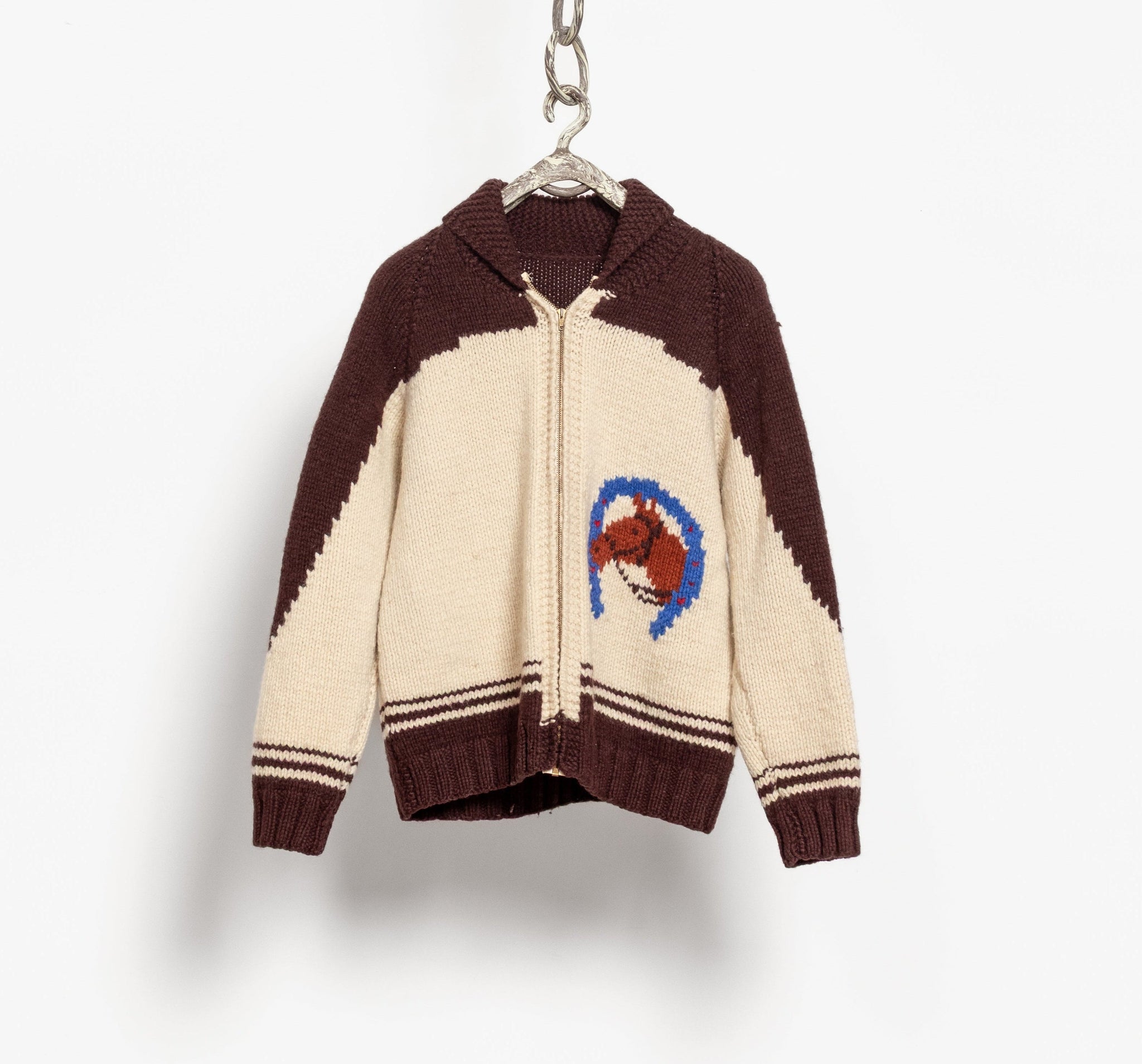 Color-blocked sweater with a logo on a hanger against a white background