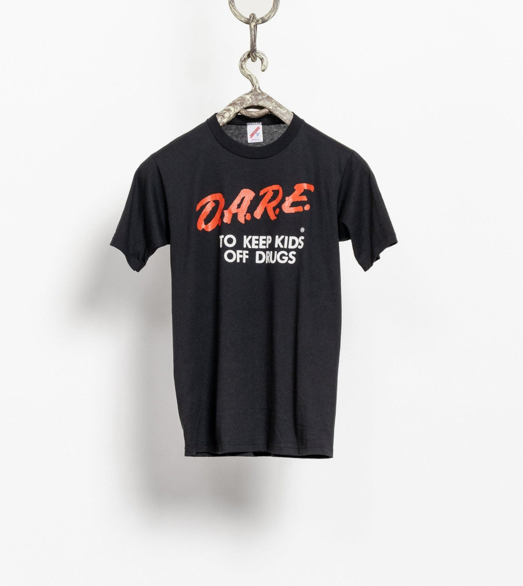 Vintage black T-shirt with 'D.A.R.E. Keep Kids Off Drugs' text printed on the front, displayed on a hanger.