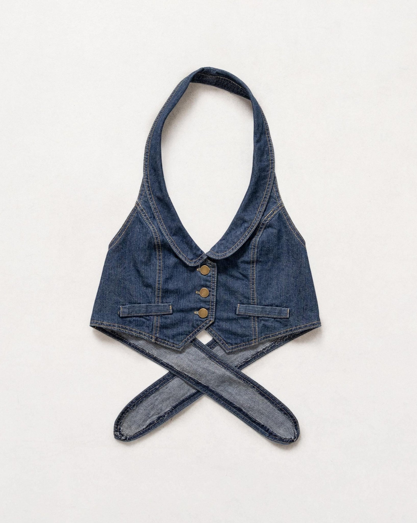 Denim halter top with a belt on a white background