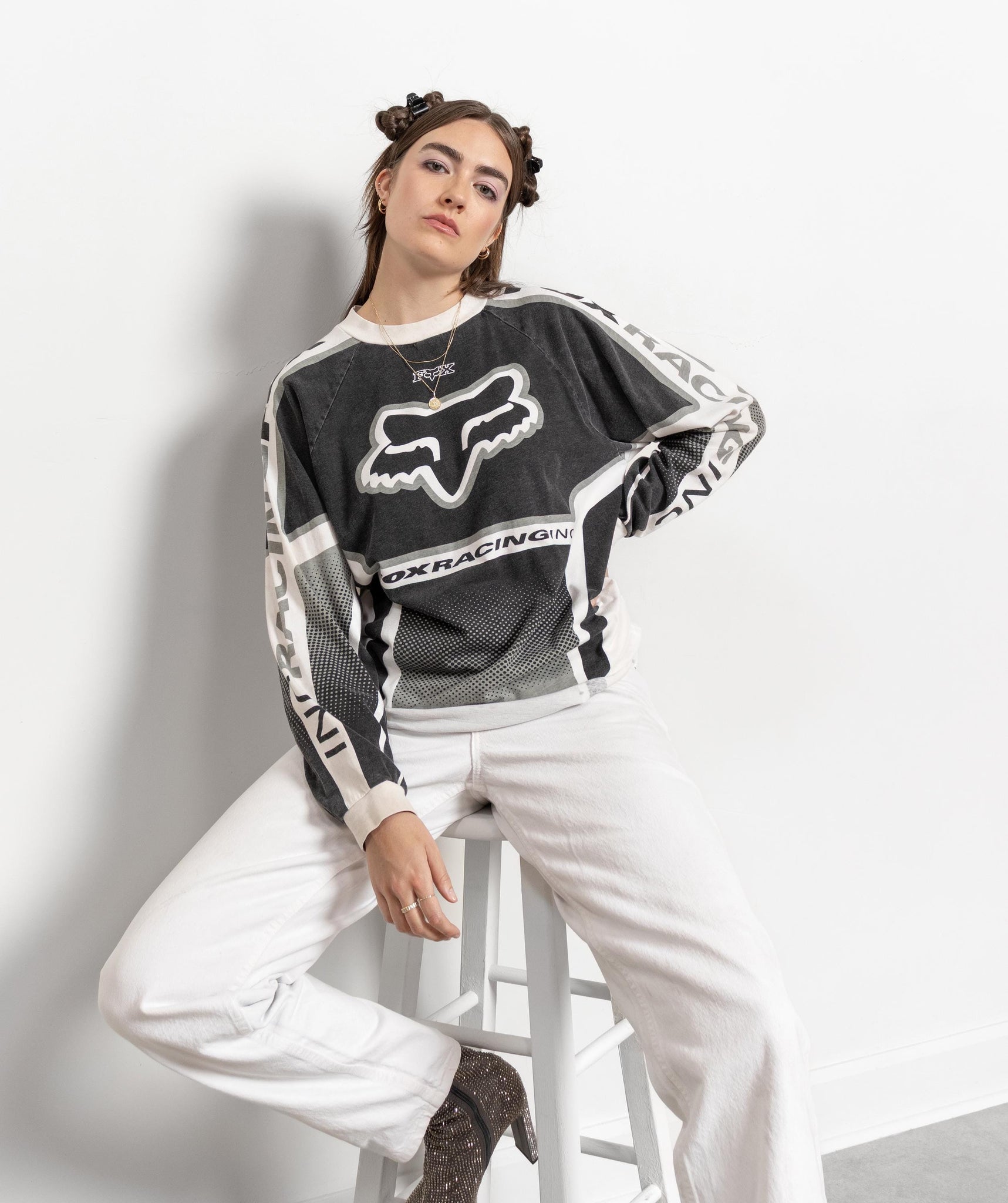 Person wearing a Fox Racing jersey and white pants on a white background